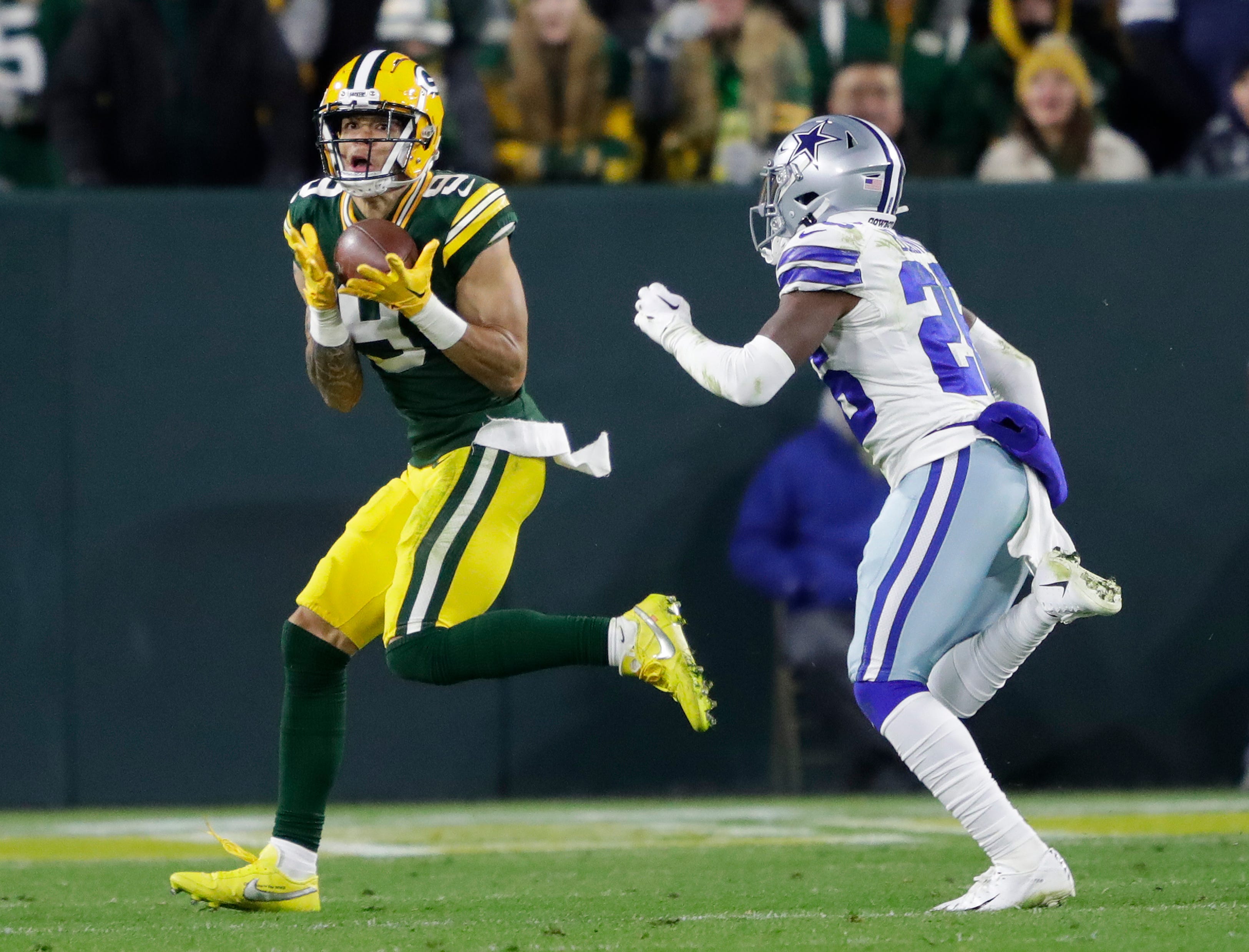 Green Bay Packers wide receiver Christian Watson (9) pulls down a touchdown reception against Dallas Cowboys cornerback DaRon Bland (26) in the fourth quarter during their football game Sunday, November 13, at Lambeau Field in Green Bay, Wis.