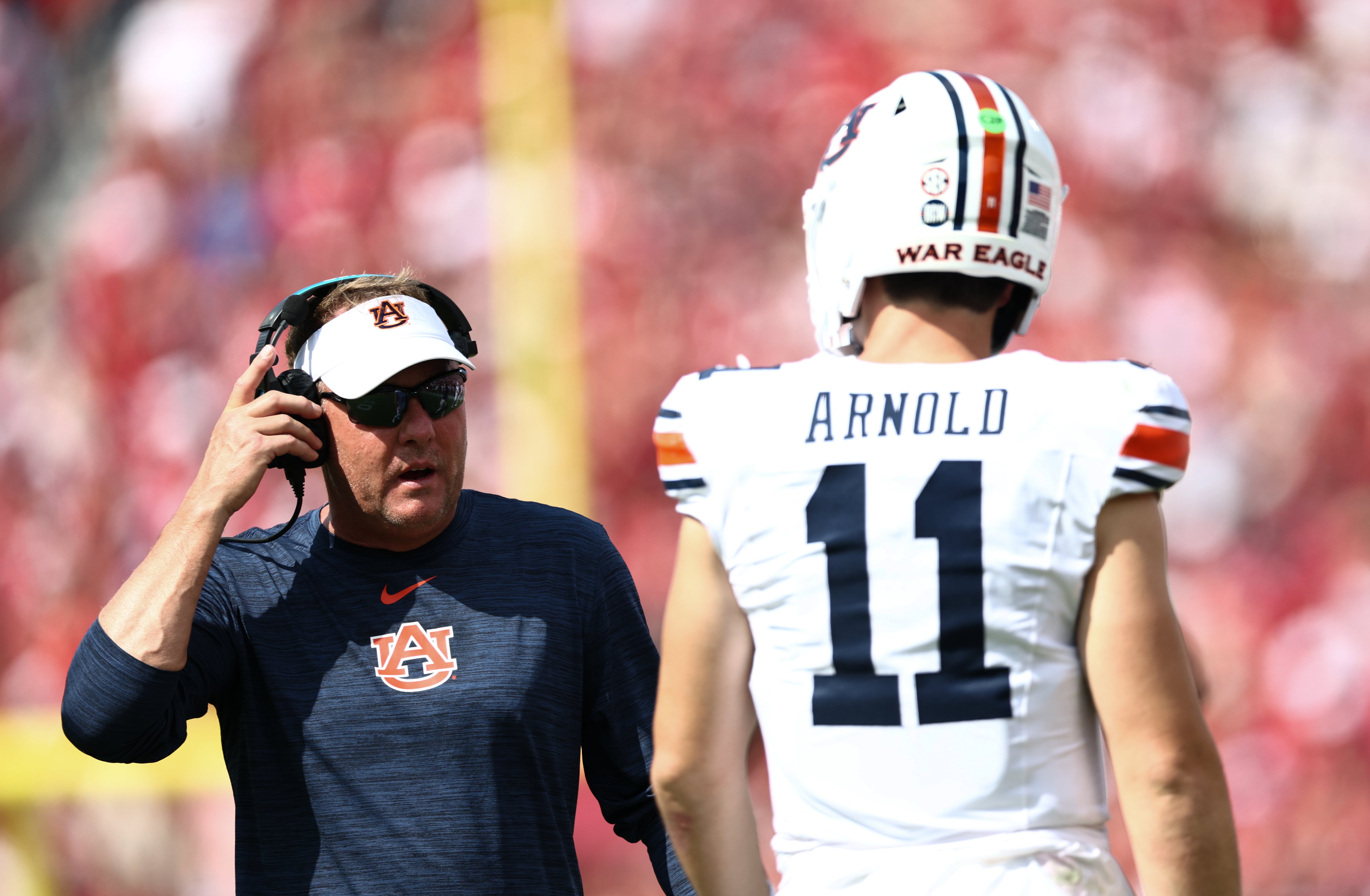 Sep 20, 2025; Norman, Oklahoma, USA; Auburn Tigers head coach Hugh Freeze speaks with Auburn Tigers quarterback Jackson Arnold (11) during the first half against the Oklahoma Sooners at Gaylord Family-Oklahoma Memorial Stadium. Mandatory Credit: Kevin Jairaj-Imagn Images