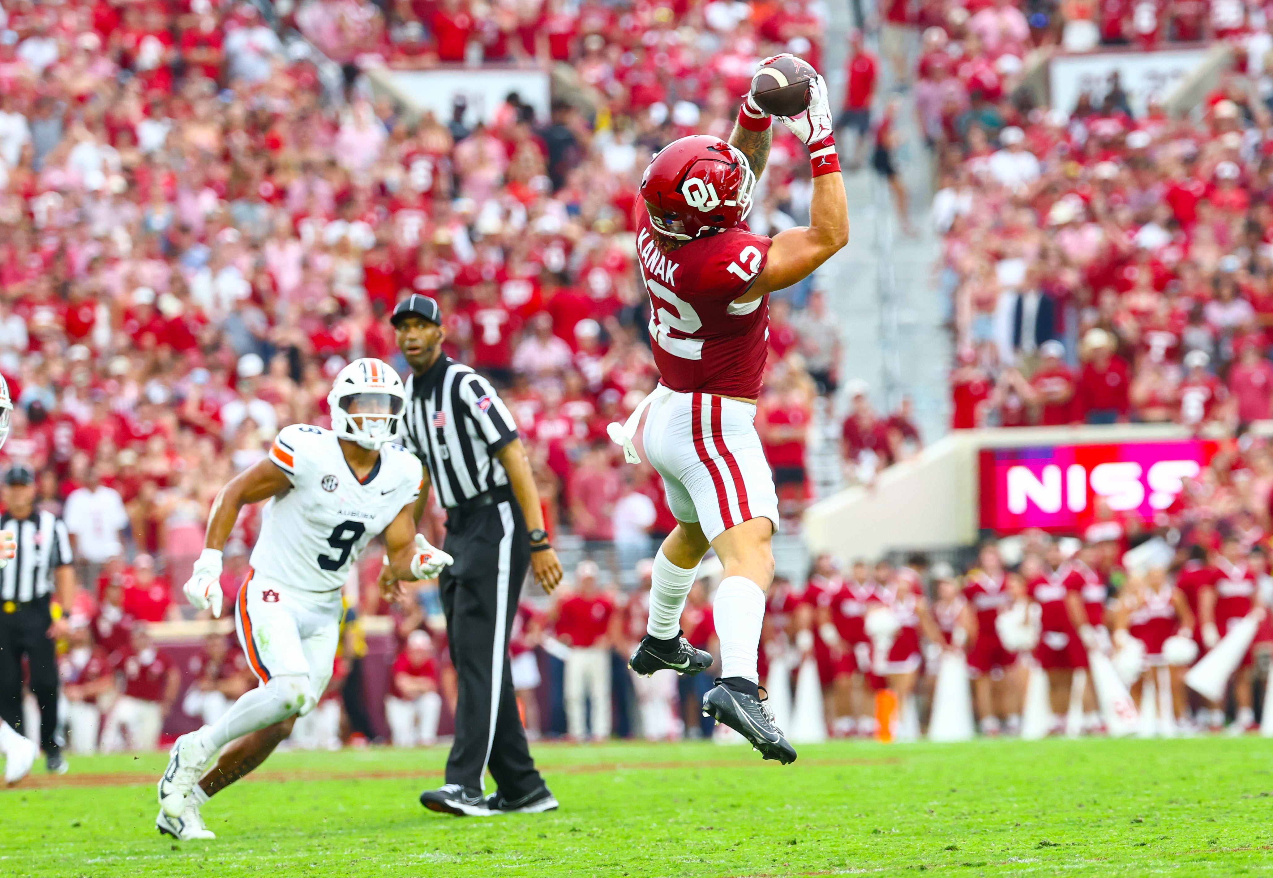 Sep 20, 2025; Norman, Oklahoma, USA; Oklahoma Sooners tight end Jaren Kanak (12) makes a catch past Auburn Tigers linebacker Elijah Melendez (9) during the second half at Gaylord Family-Oklahoma Memorial Stadium.