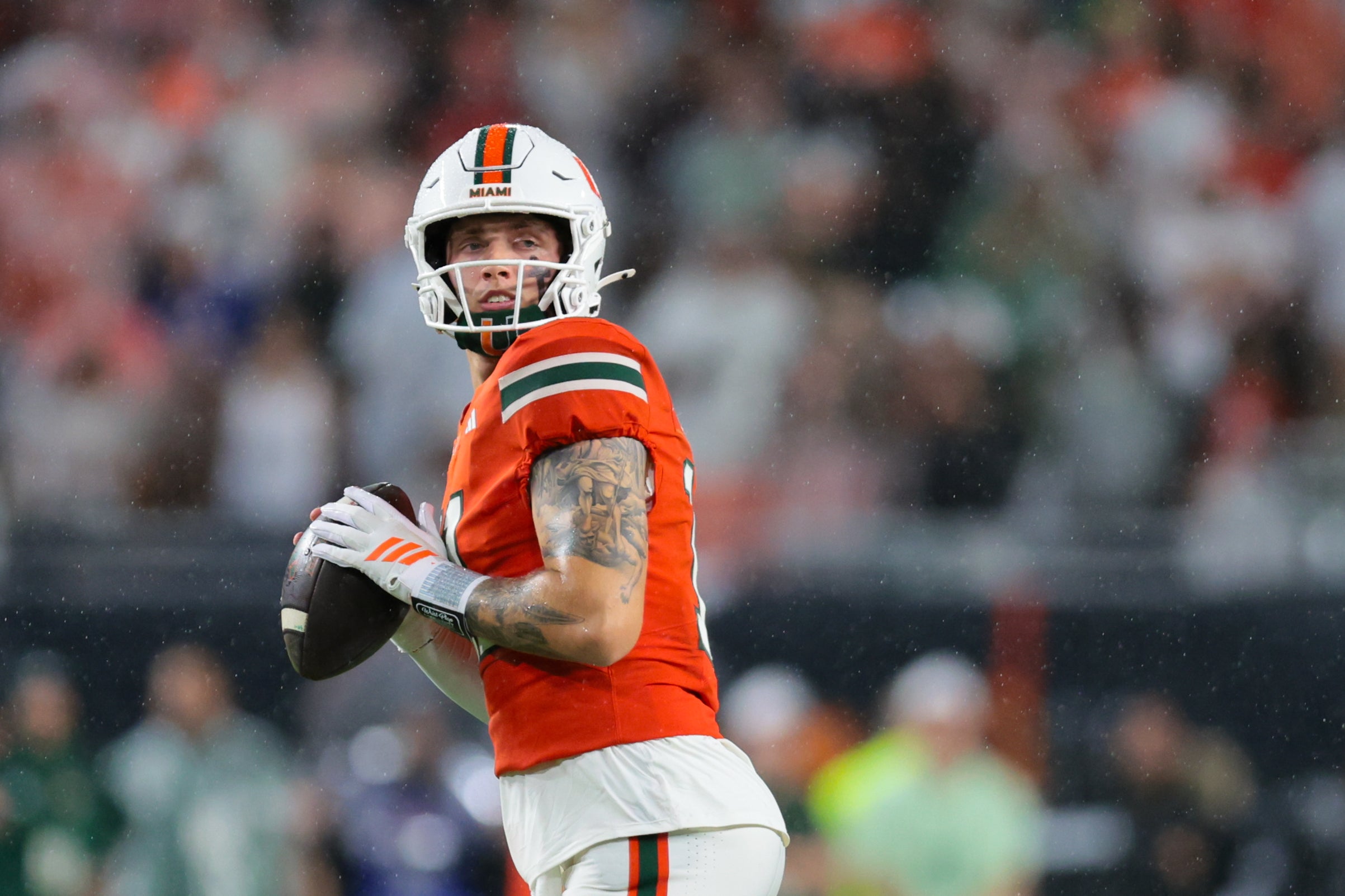 Sep 20, 2025; Miami Gardens, Florida, USA; Miami Hurricanes quarterback Carson Beck (11) looks for passing option against the Florida Gators during the first quarter at Hard Rock Stadium.
