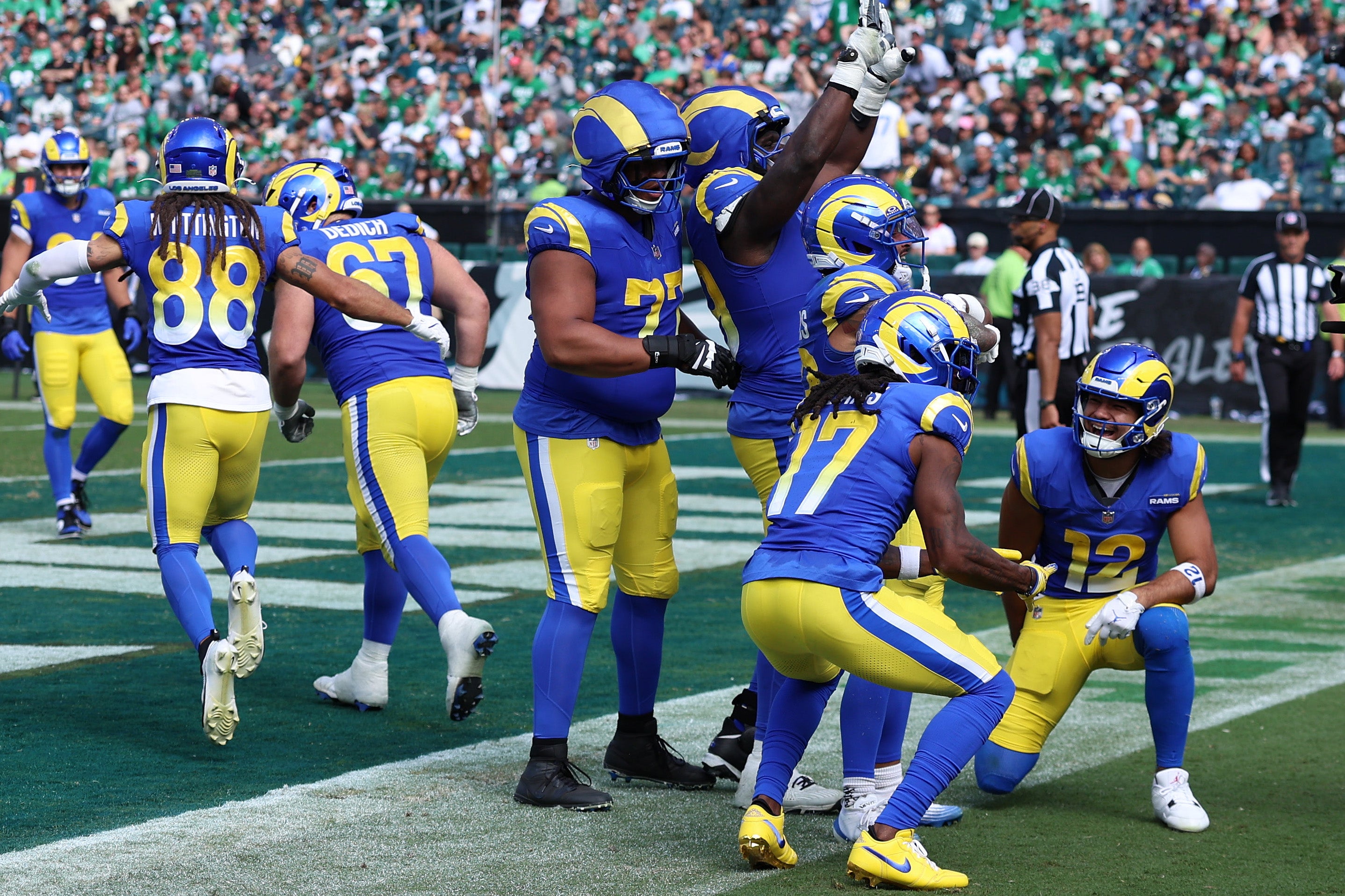 Los Angeles Rams running back Kyren Williams (23) reacts with wide receiver Davante Adams (17) and wide receiver Puka Nacua (12) after a touchdown