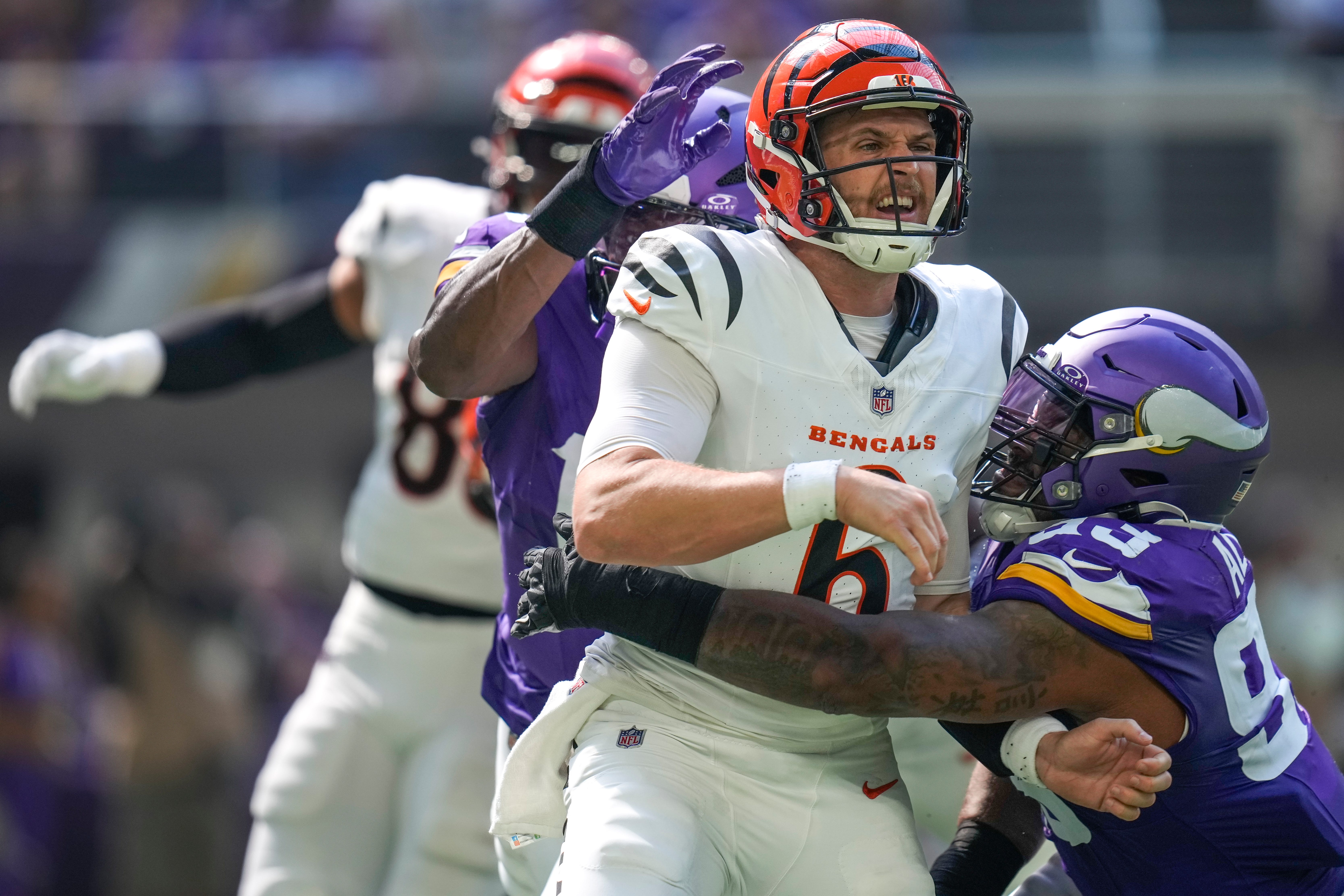Cincinnati Bengals quarterback Jake Browning (6) is knocked down by Minnesota Vikings defensive tackle Jonathan Allen (93) as he gets a pass off in the second quarter of the NFL Week 3 game between the Minnesota Vikings and the Cincinnati Bengals at U.S. Bank Stadium in Minneapolis on Sunday, Sept. 21, 2025.