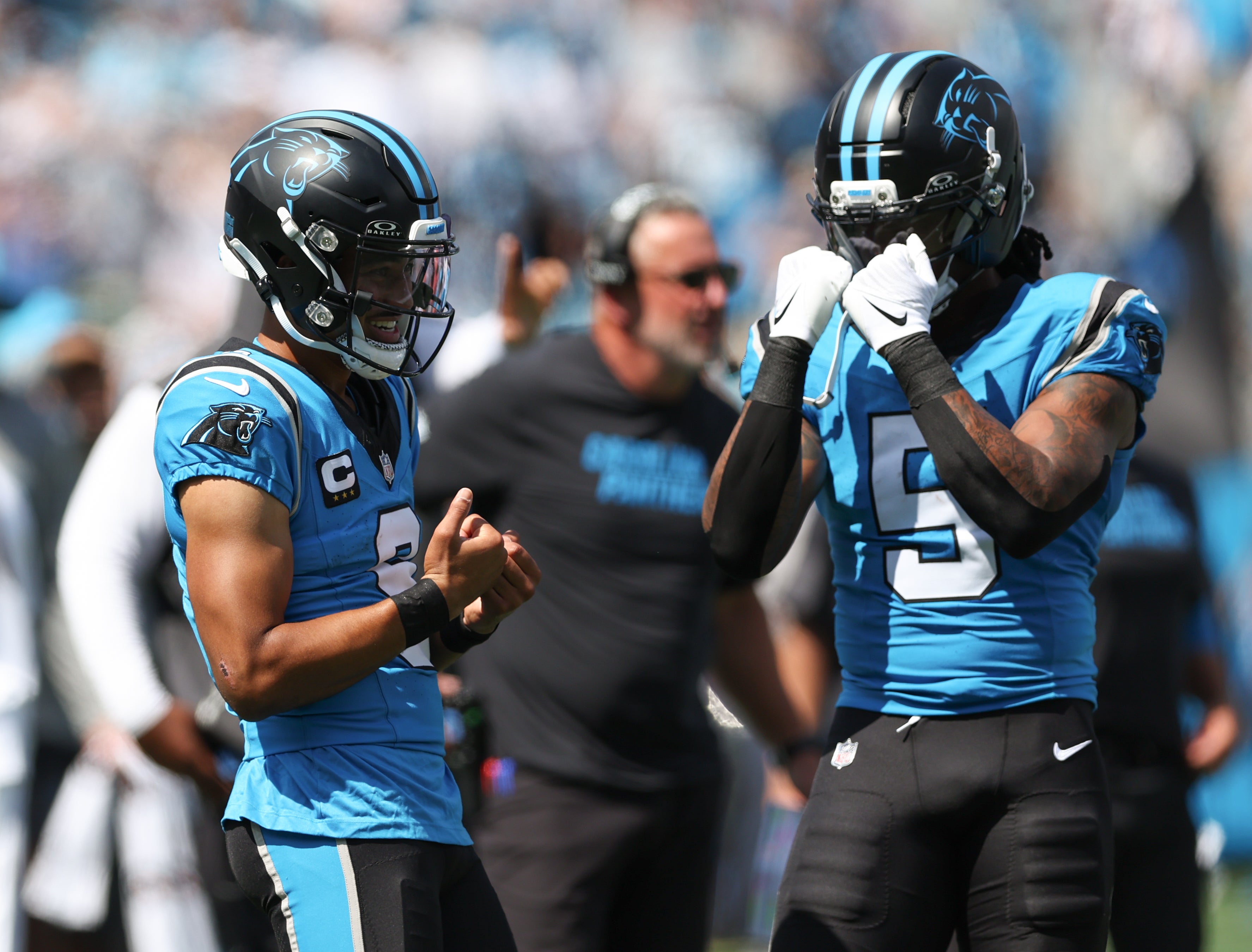 Sep 21, 2025; Charlotte, North Carolina, USA; Carolina Panthers quarterback Bryce Young (left) celebrates with running back Rico Dowdle (5) after scoring a touchdown during the second half of a game against the Atlanta Falcons at Bank of America Stadium.
