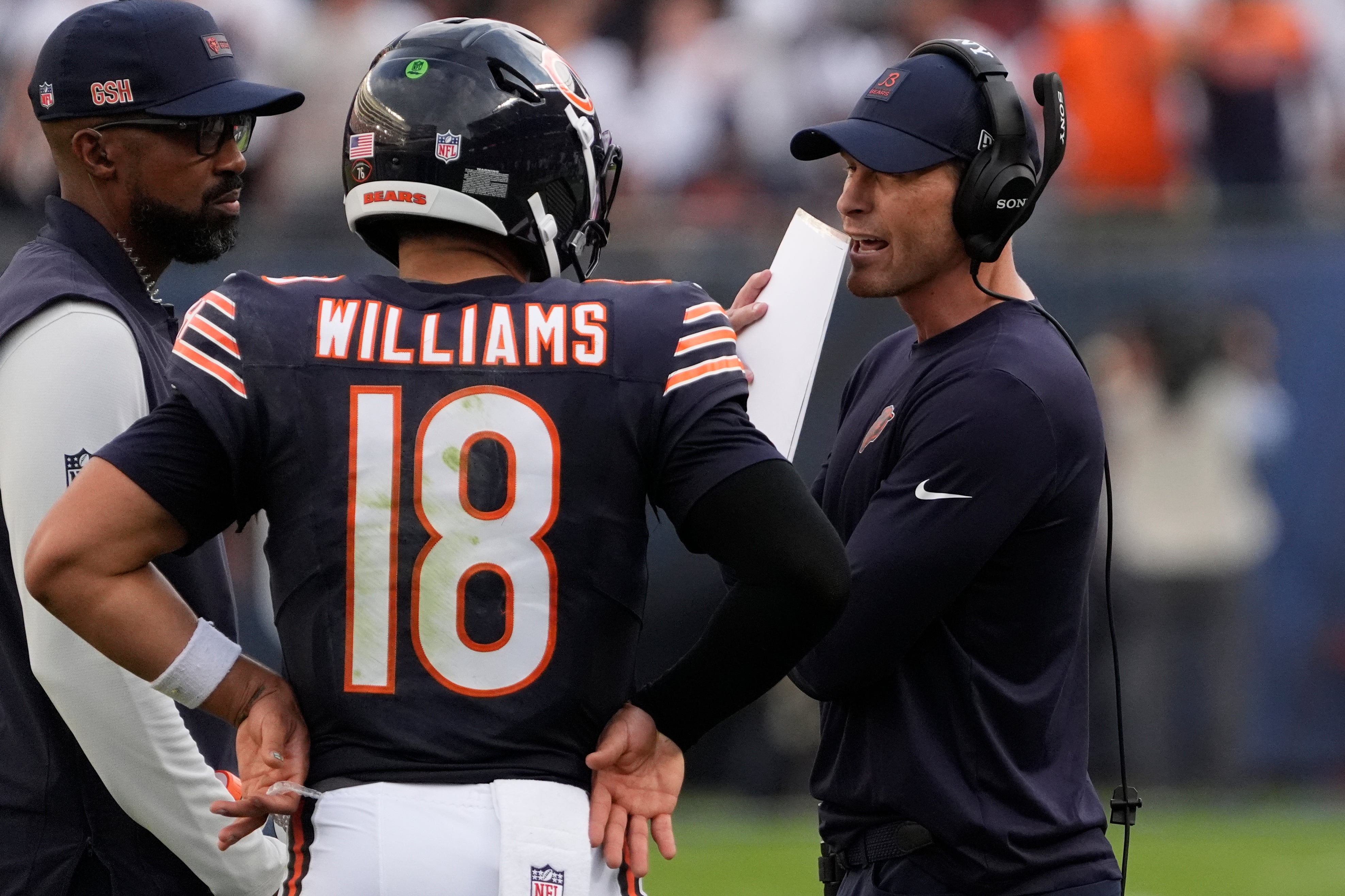 Sep 21, 2025; Chicago, Illinois, USA; Chicago Bears head coach Ben Johnson talks with quarterback Caleb Williams (18) against the Dallas Cowboys during the second half at Soldier Field.