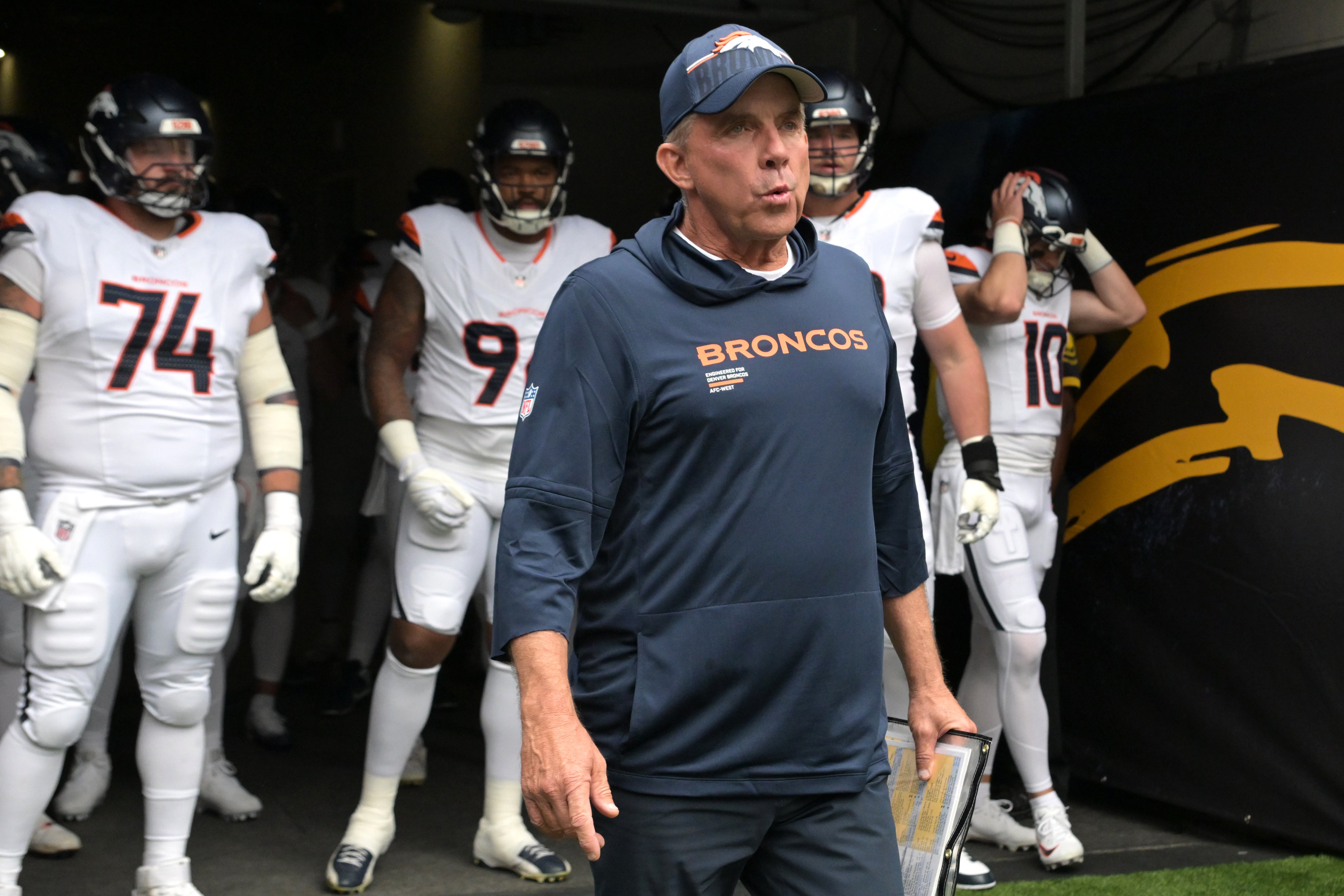 Sep 21, 2025; Inglewood, California, USA; Denver Broncos head coach Sean Payton leads his film on to the field for the game against the Los Angeles Chargers at SoFi Stadium.