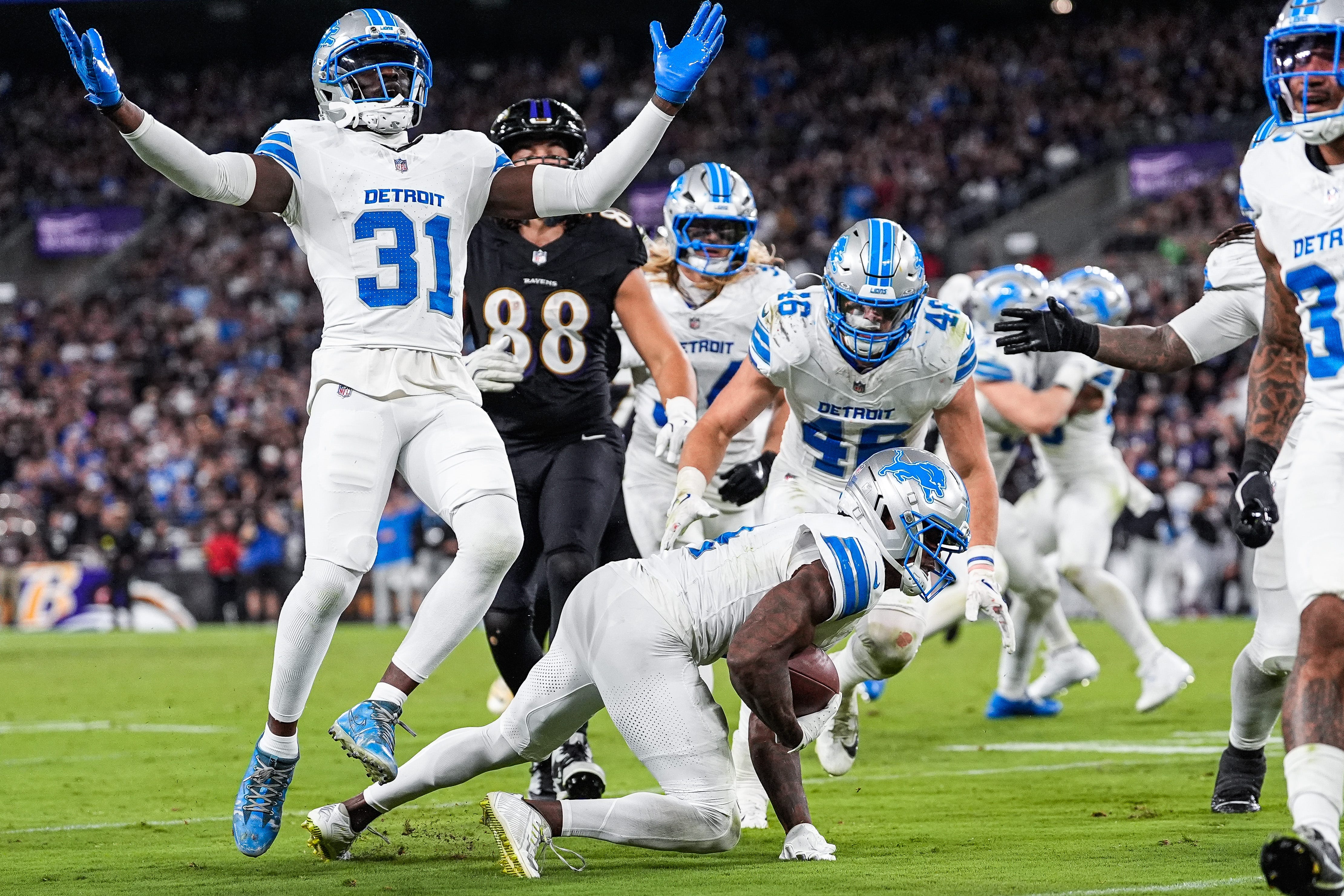 Detroit Lions cornerback DJ. Reed (4), center, recovers a Baltimore Ravens fumble as safety Kerby Joseph (31), left, celebrates during the second half at M&T Bank Stadium in Baltimore, Md. on Monday, Sept. 22, 2025.