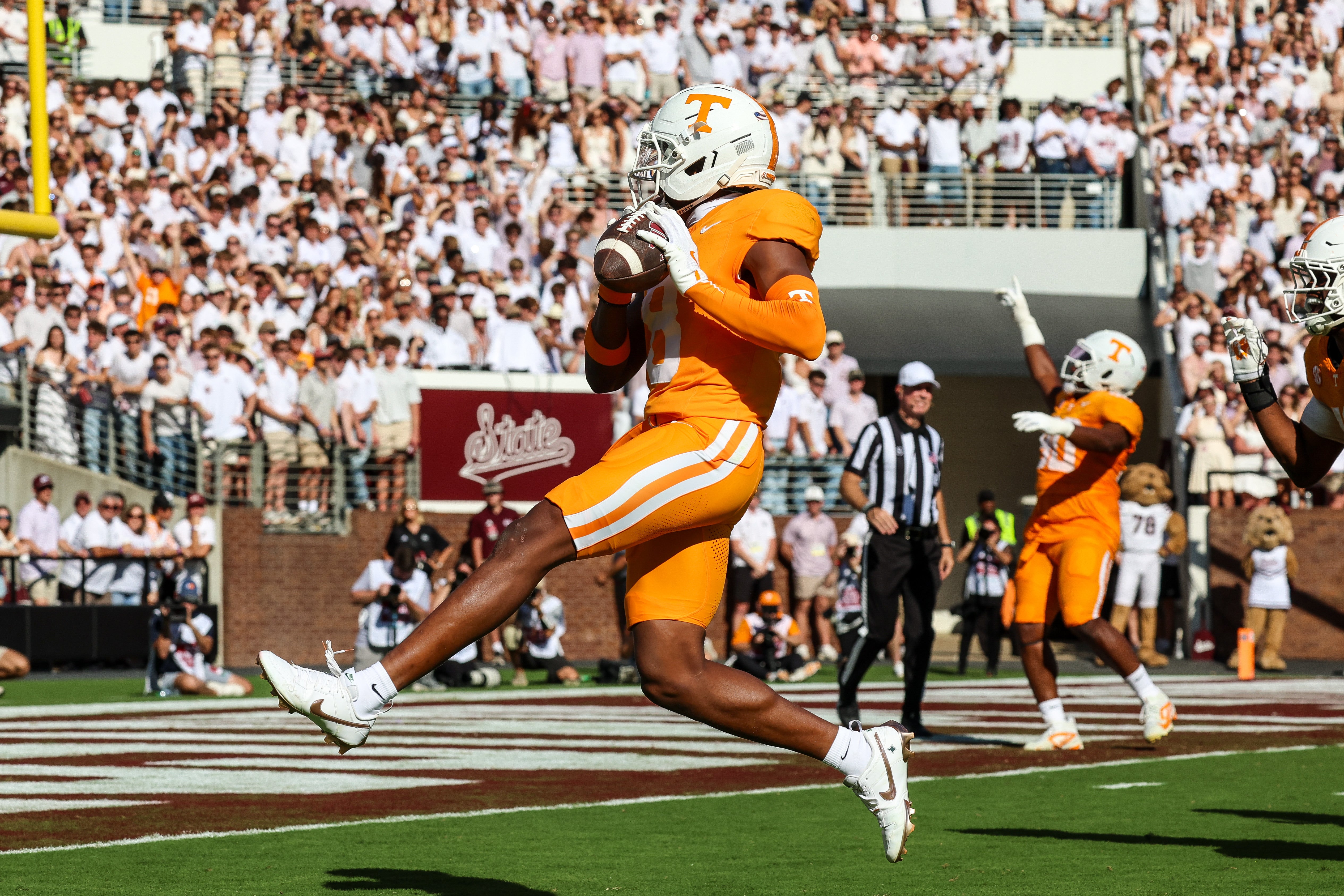 Sep 27, 2025; Starkville, Mississippi, USA; Tennessee Volunteers defensive back Colton Hood (8) scores a touchdown after an interception against the Mississippi State Bulldogs during the first half at Davis Wade Stadium at Scott Field.