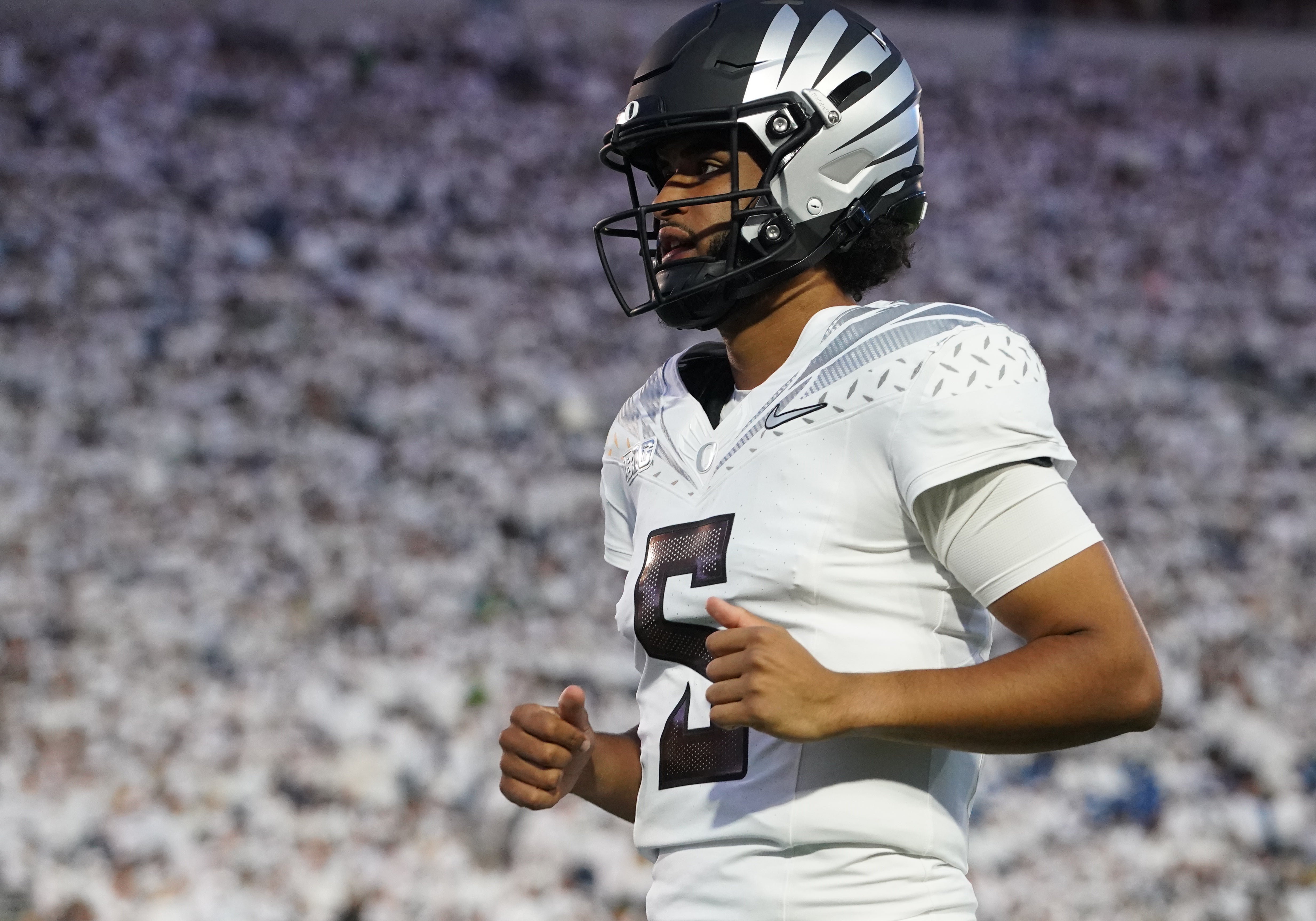 Sep 27, 2025; University Park, Pennsylvania, USA; Oregon Ducks quarterback Dante Moore (5) warms up before a game against the Penn State Nittany Lions at Beaver Stadium. Mandatory Credit: James Lang-Imagn Images