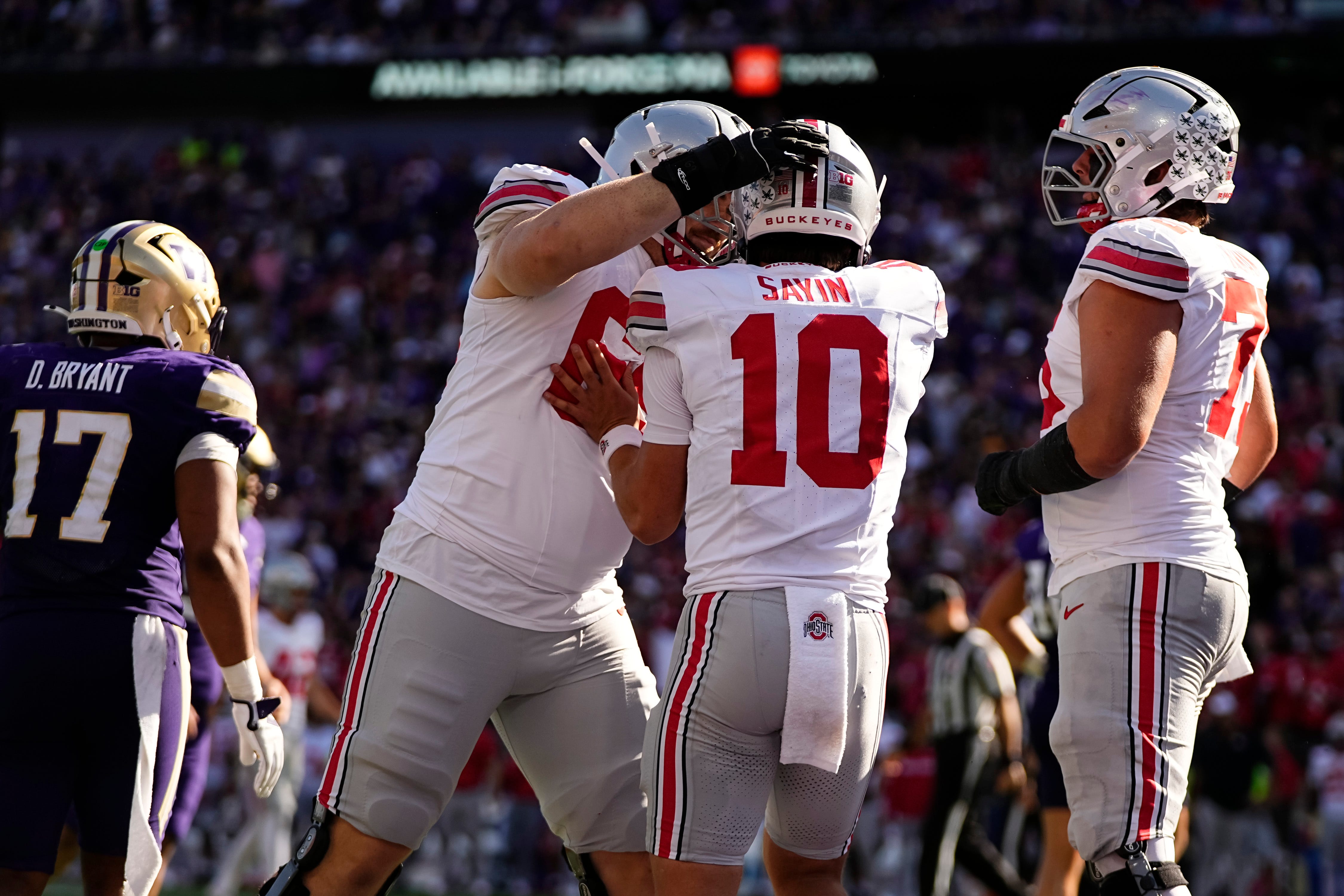 Ohio State Buckeyes offensive lineman Ian Moore (69) celebrates a touchdown pass by quarterback Julian Sayin (10) during the second half of the NCAA football game at Husky Stadium in Seattle on Sept. 27, 2025. Ohio State won 24-6.