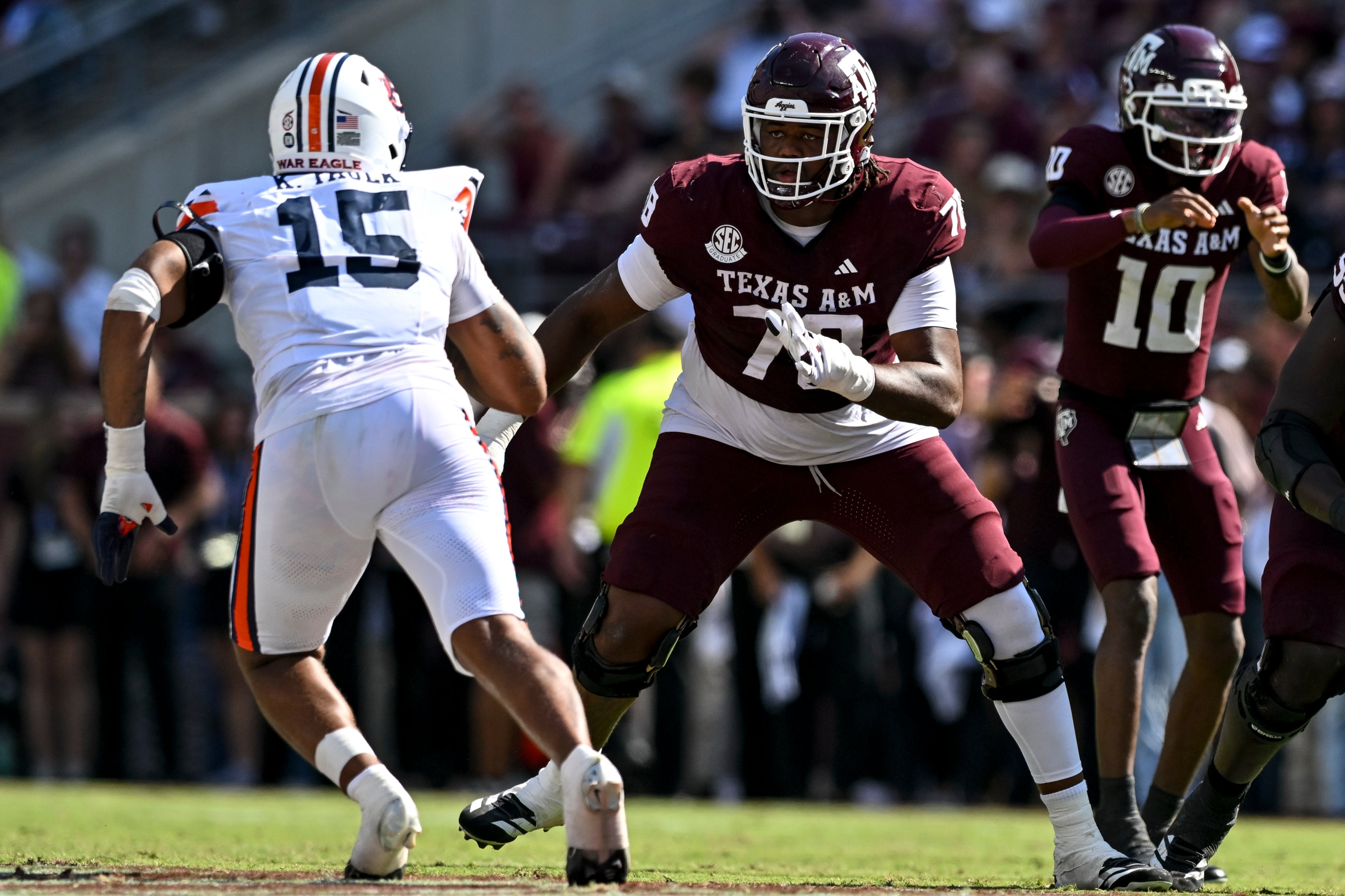 Sep 27, 2025; College Station, Texas, USA; Texas A&M Aggies offensive lineman Jonte Newman (75) blocks against Auburn Tigers defensive end Keldric Faulk (15) at Kyle Field. Mandatory Credit: Maria Lysaker-Imagn Images