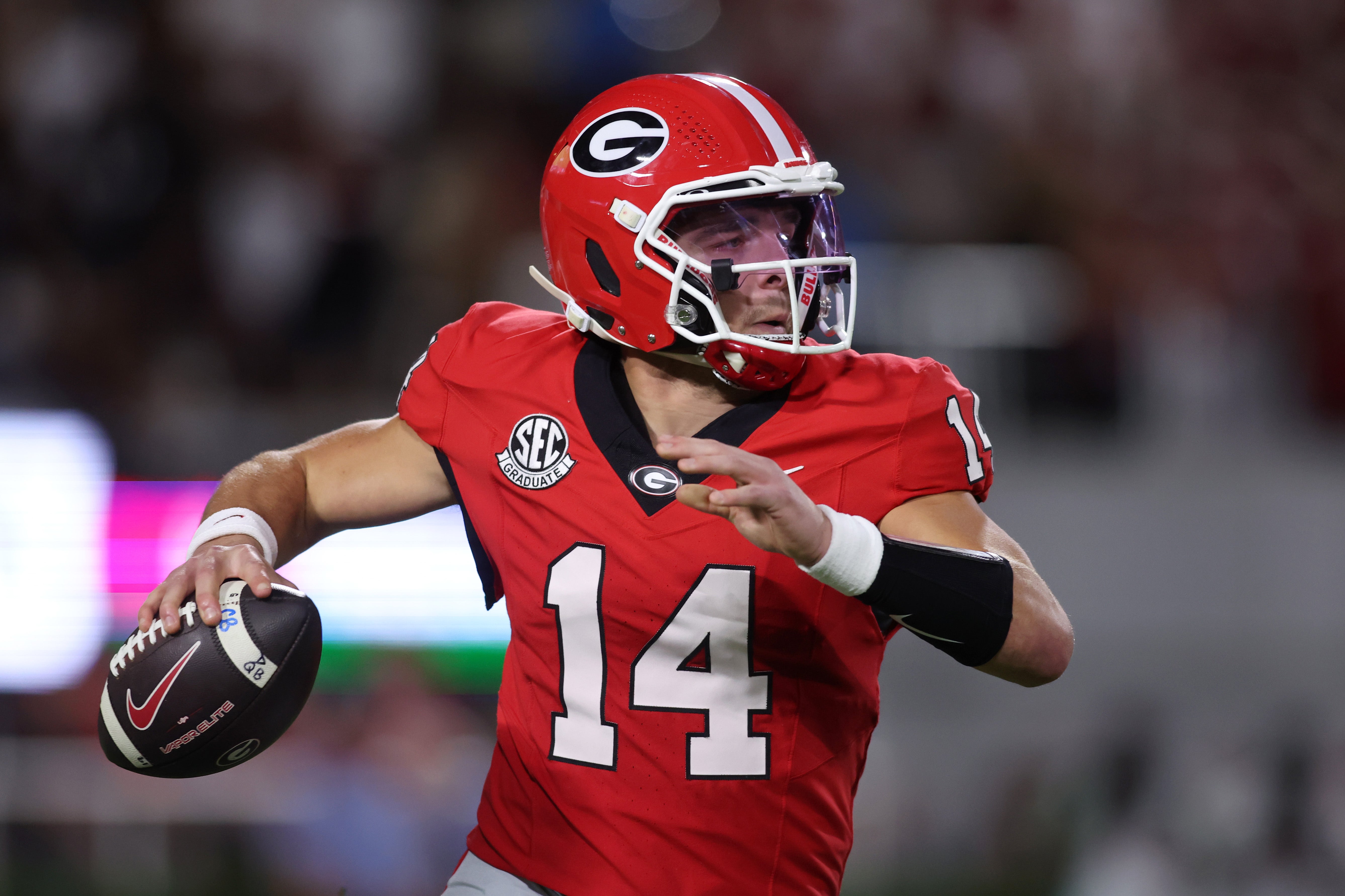 Georgia Bulldogs quarterback Gunner Stockton (14) passes against the Alabama Crimson Tide in the first half at Sanford Stadium.