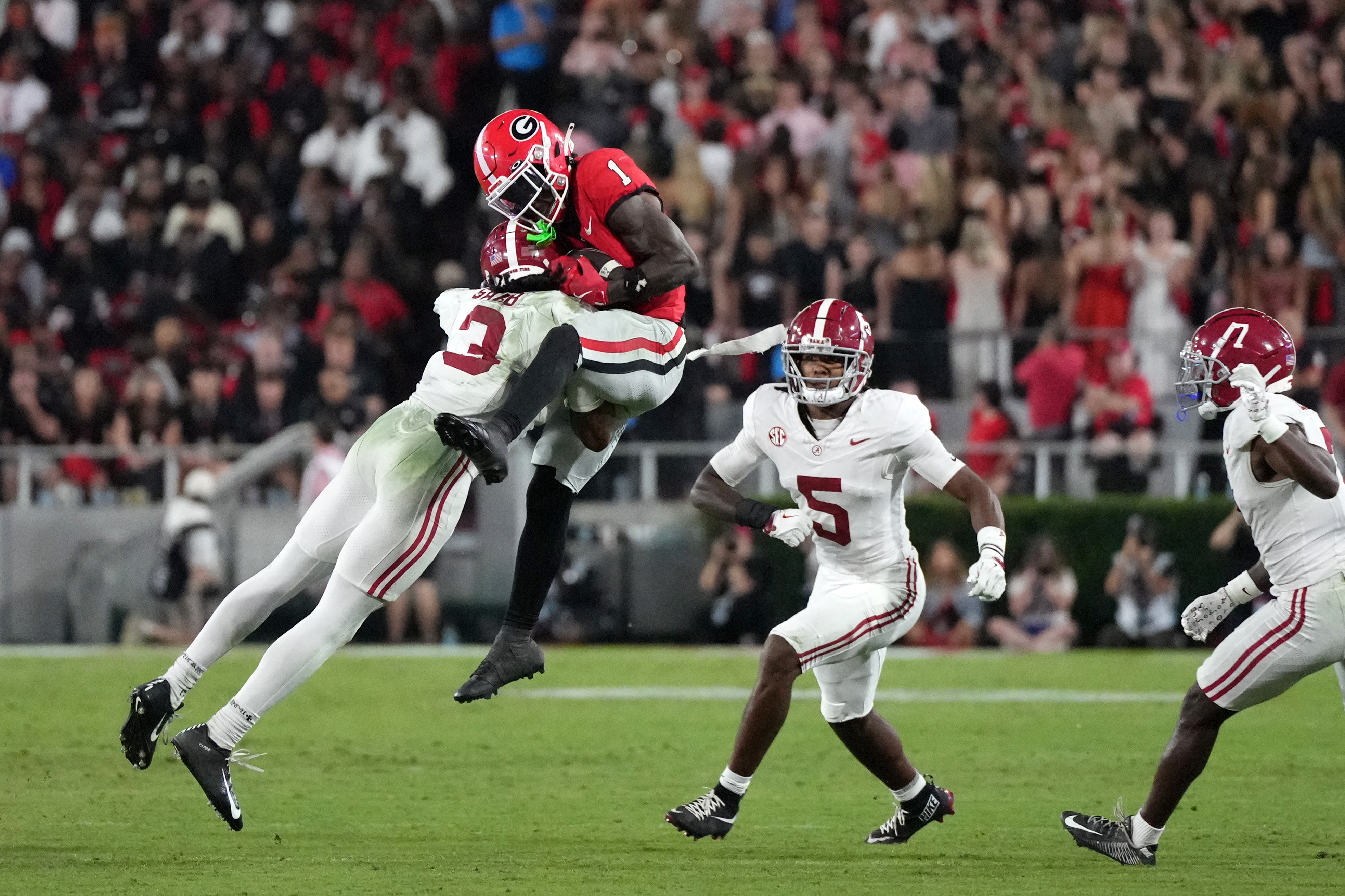 Sep 27, 2025; Athens, Georgia, USA; Alabama Crimson Tide defensive back Keon Sabb (3) tackles Georgia Bulldogs wide receiver Zachariah Branch (1) in the second half at Sanford Stadium.
