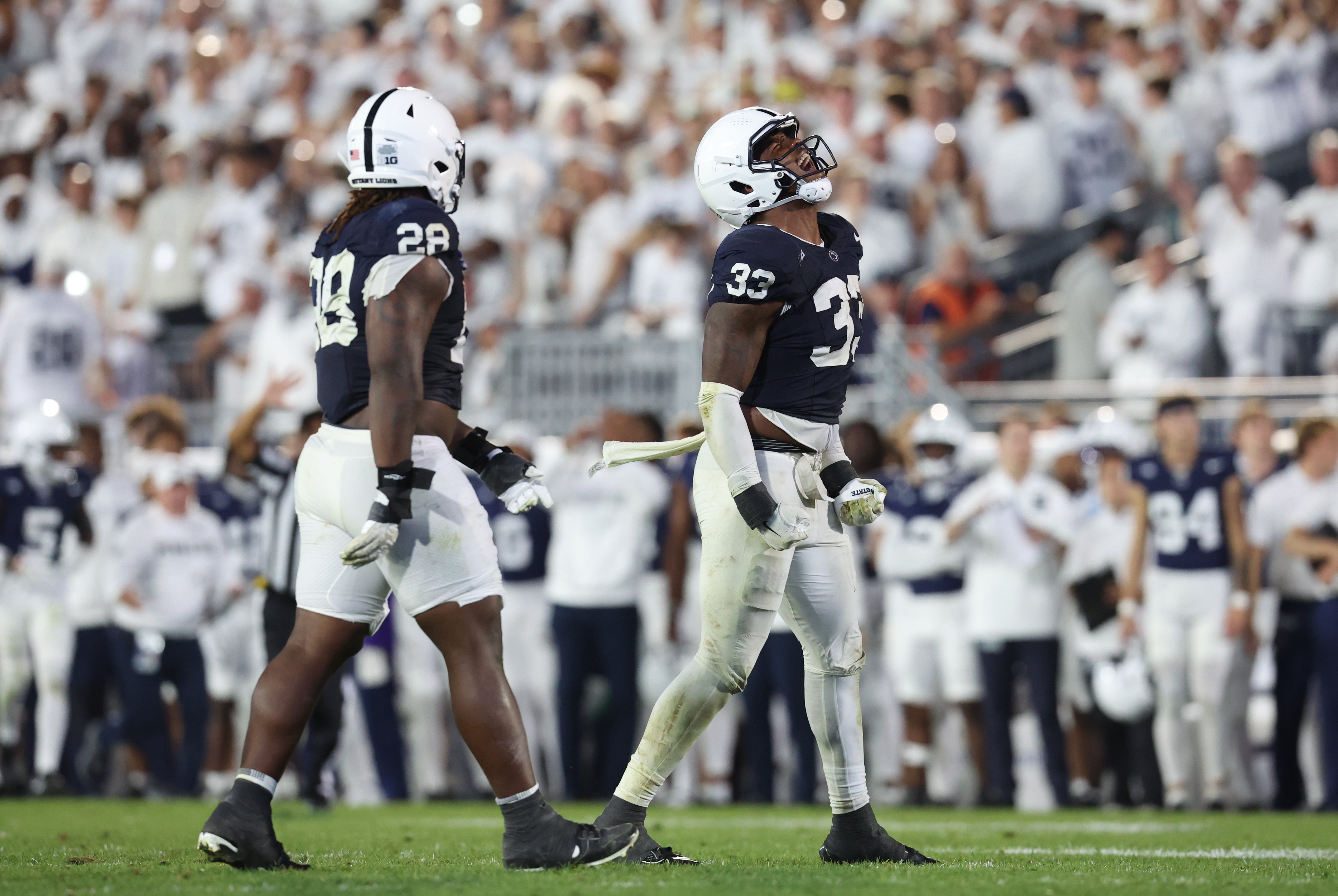 Sep 27, 2025; University Park, Pennsylvania, USA; Penn State Nittany Lions safety Karson Kiesewetter (28) and defensive end Dani Dennis-Sutton (33) react during the fourth quarter at Beaver Stadium. Mandatory Credit: Matthew O'Haren-Imagn Images