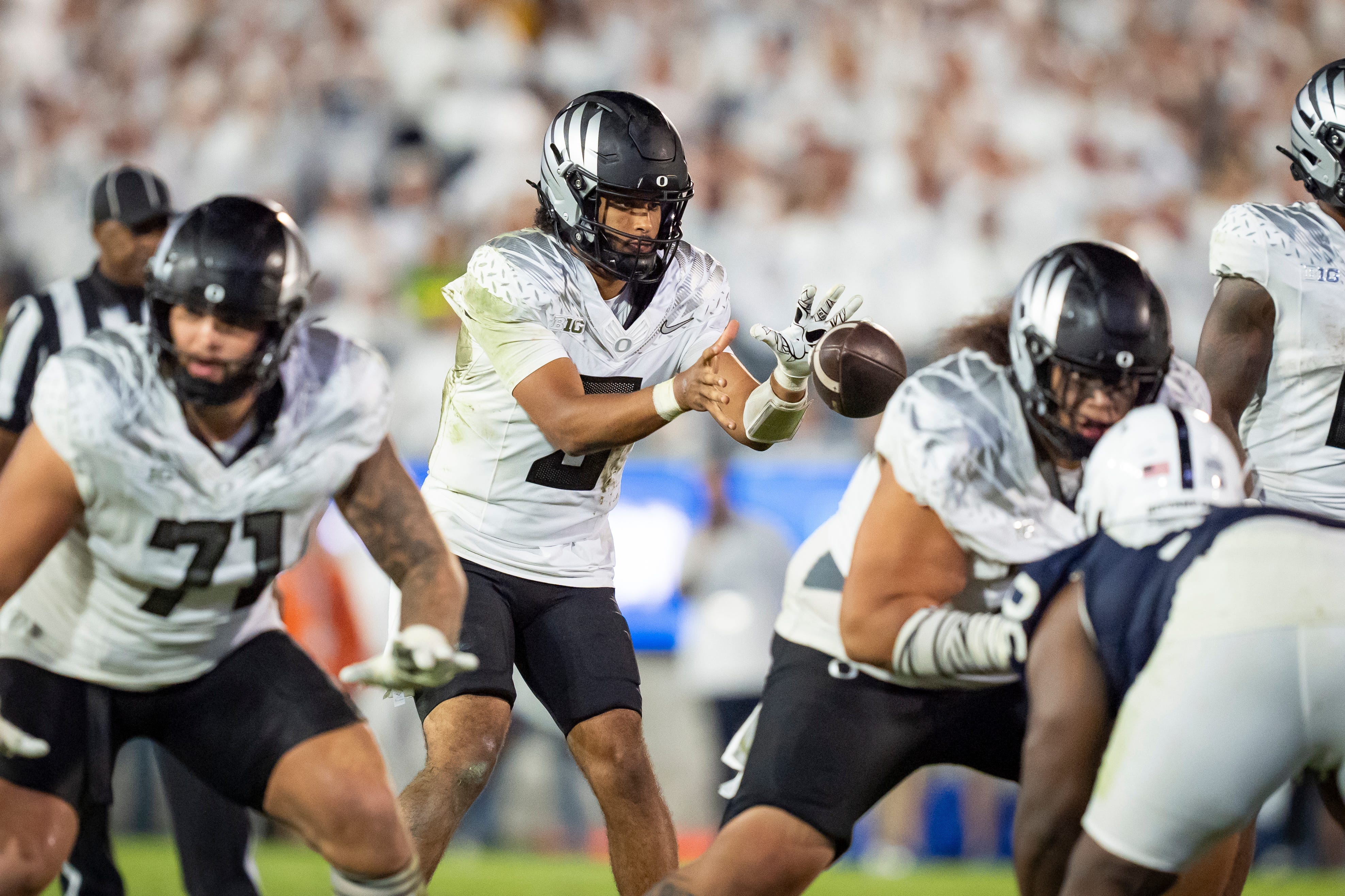 Oregon quarterback Dante Moore takes a snap as the Oregon Ducks face the Penn State Nittany Lions on Sept. 27, 2025, at Beaver Stadium in University Park, Pennsylvania.