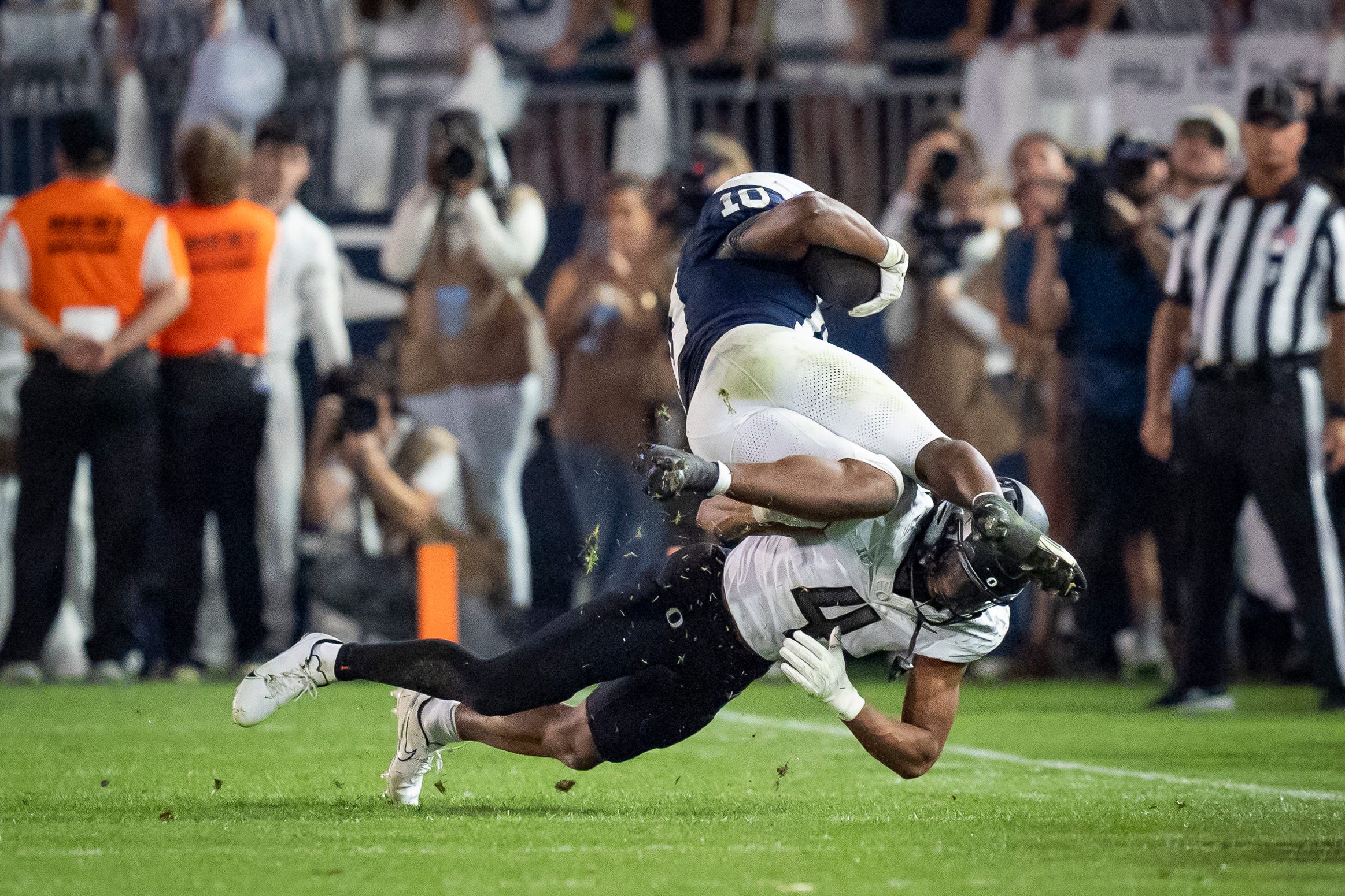 Oregon defensive back Brandon Finney Jr. trips up Penn State running back Nicholas Singleton as the Oregon Ducks face the Penn State Nittany Lions on Sept. 27, 2025, at Beaver Stadium in University Park, Pennsylvania.