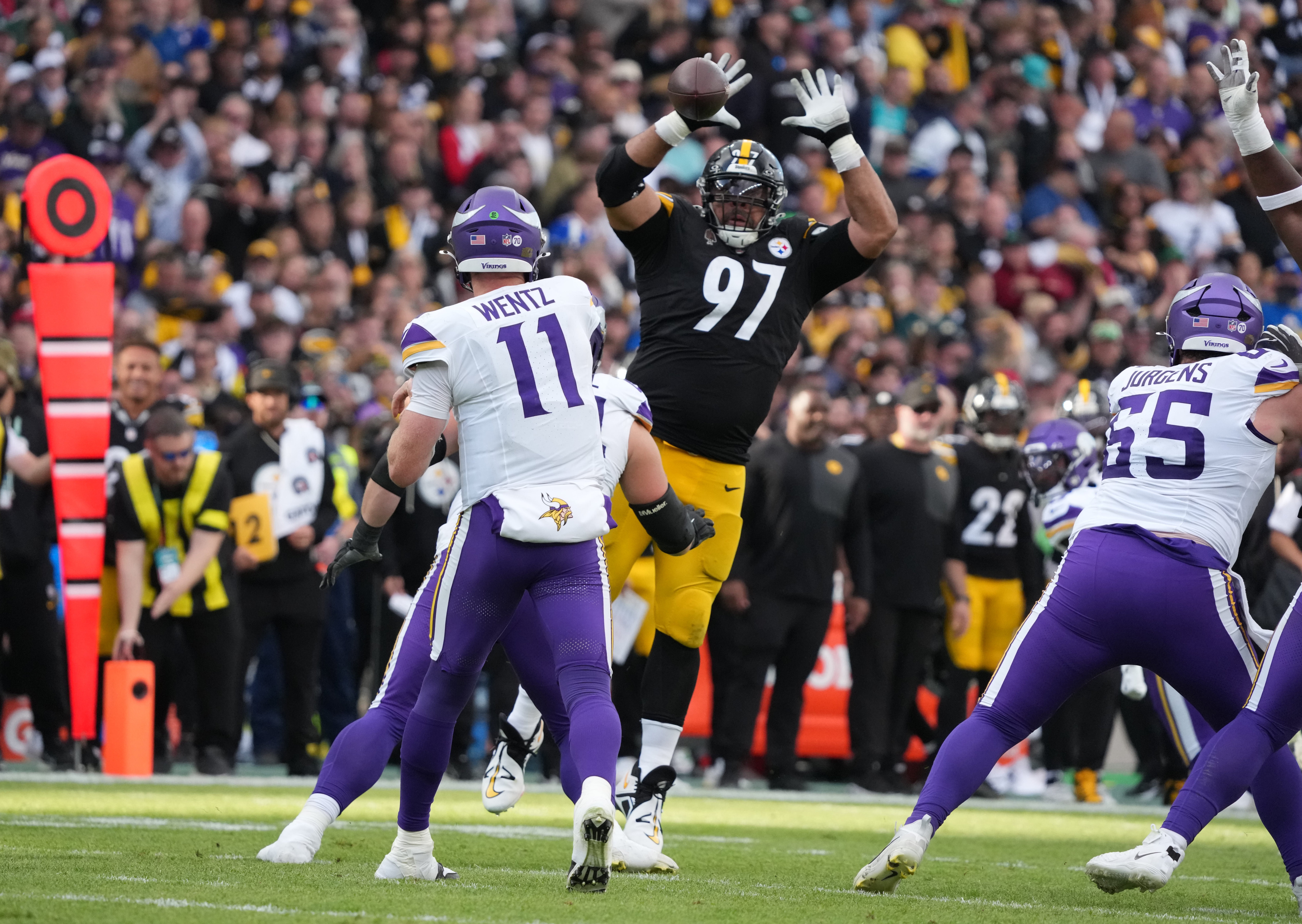 Sep 28, 2025; Dublin, Ireland; Minnesota Vikings quarterback Carson Wentz (11) throws downfield past Pittsburgh Steelers defensive tackle Cameron Heyward (97) during the fourth quarter during an NFL International Series game at Croke Park.