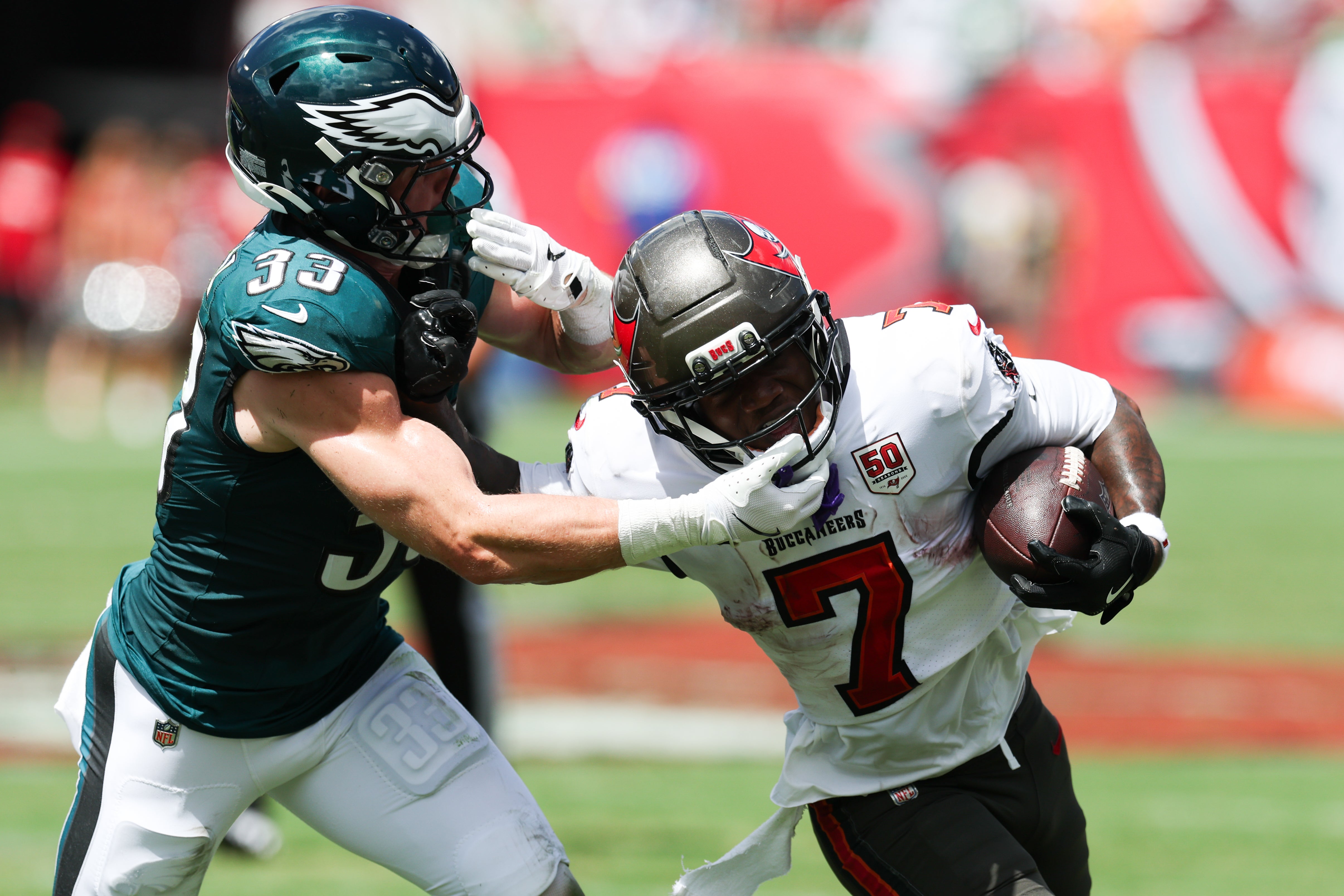 Sep 28, 2025; Tampa, Florida, USA; Tampa Bay Buccaneers running back Bucky Irving (7) attempts to stiff arm Philadelphia Eagles cornerback Cooper Dejean (33) during the first quarter at Raymond James Stadium.
