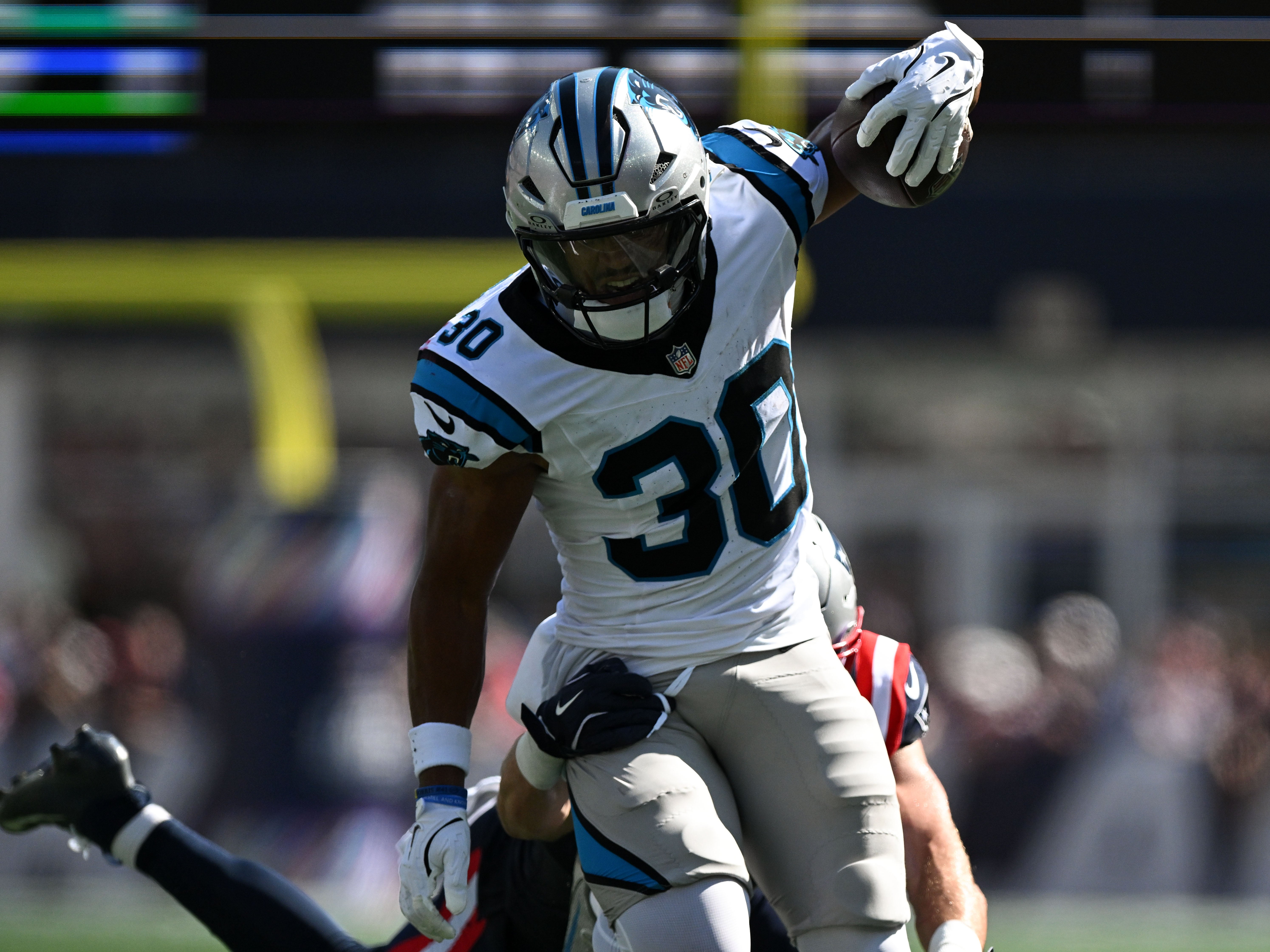 Sep 28, 2025; Foxborough, Massachusetts, USA; Carolina Panthers running back Chuba Hubbard (30) runs against the New England Patriots during the first half at Gillette Stadium.