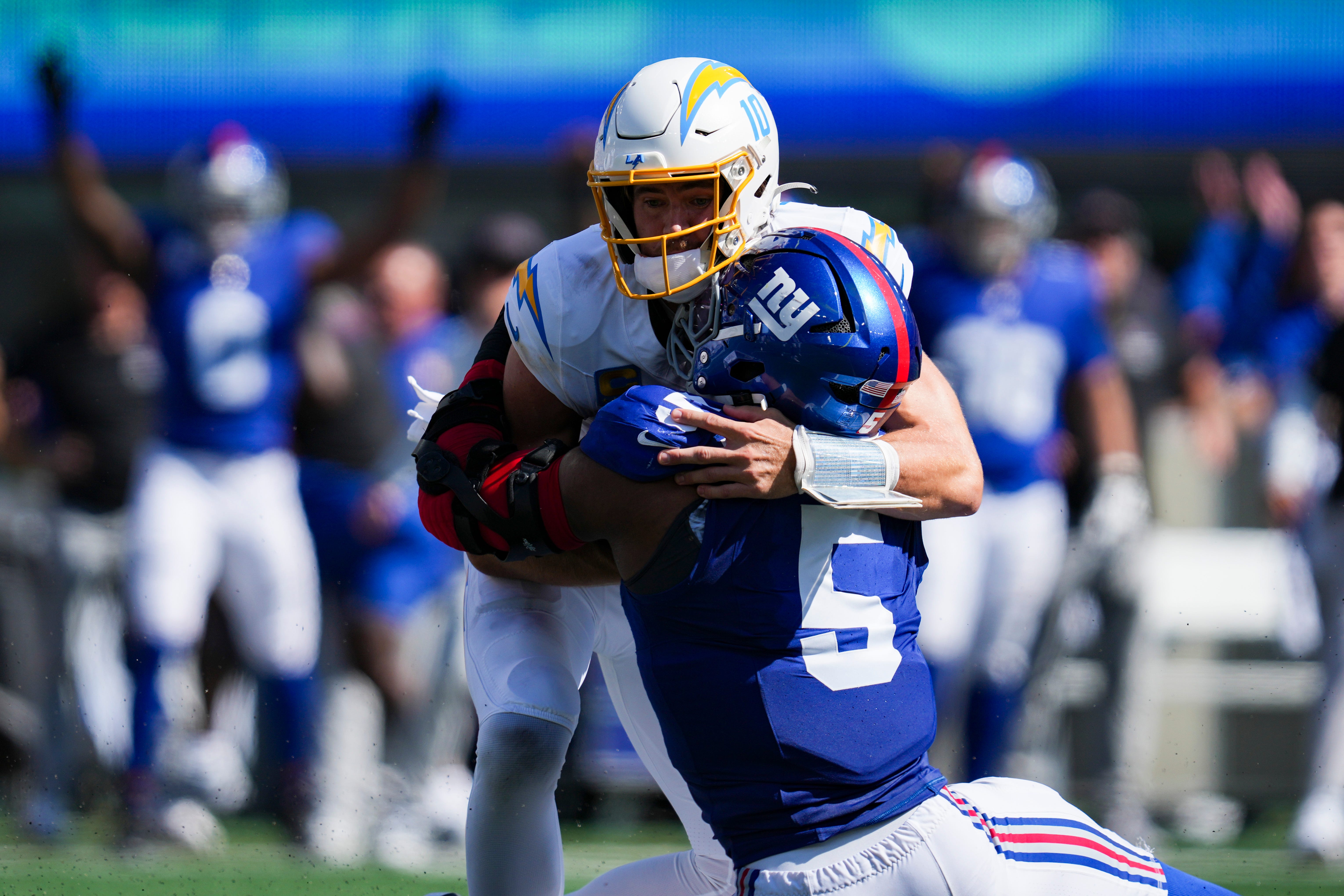 New York Giants linebacker Kayvon Thibodeaux (5) tackles Los Angeles Chargers quarterback Justin Herbert (10) during a game at MetLife Stadium, Sep 28, 2025, East Rutherford, NJ, USA.