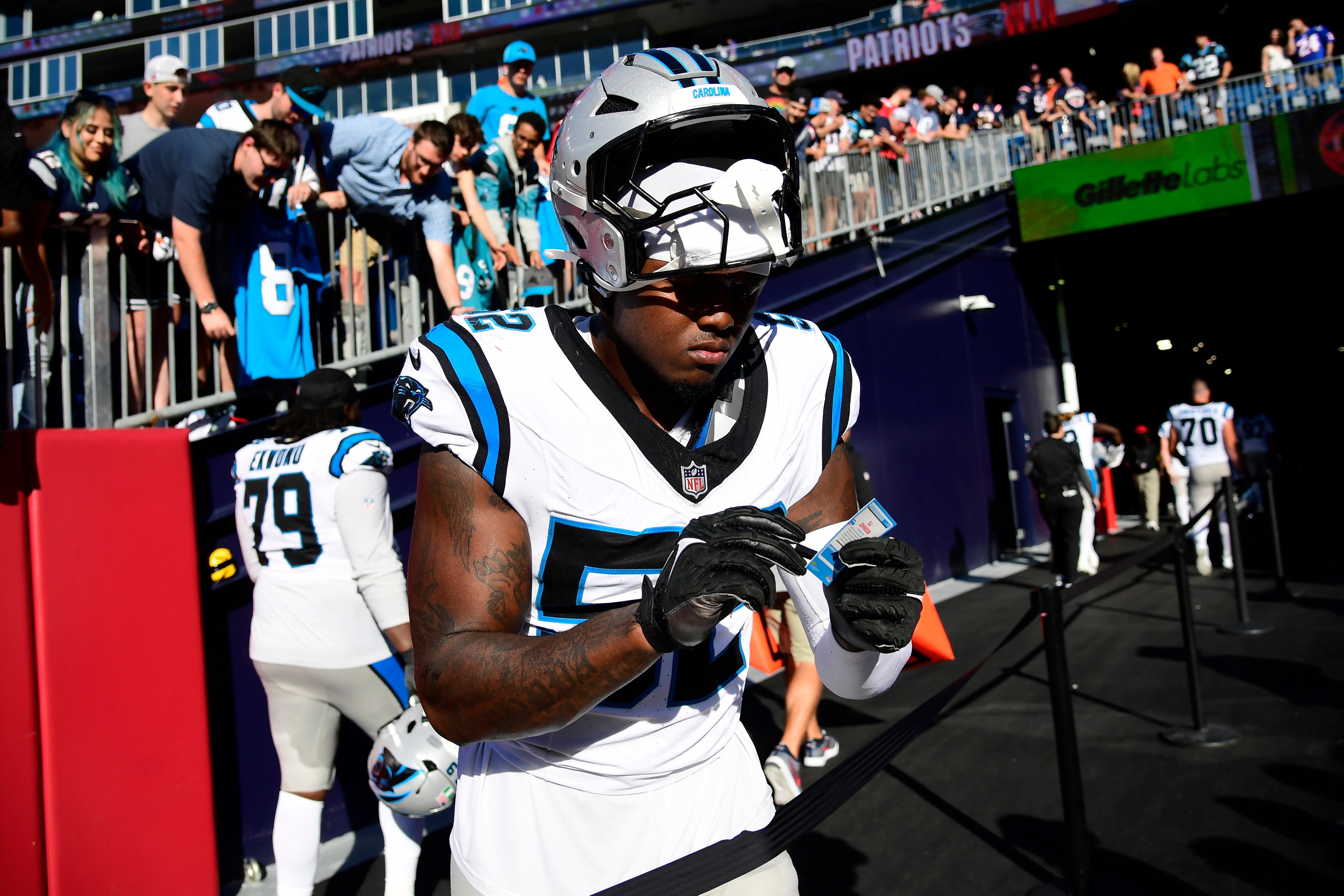 Sep 28, 2025; Foxborough, Massachusetts, USA; Carolina Panthers linebacker DJ Johnson (52) signs an autograph after the game against the New England Patriots at Gillette Stadium.