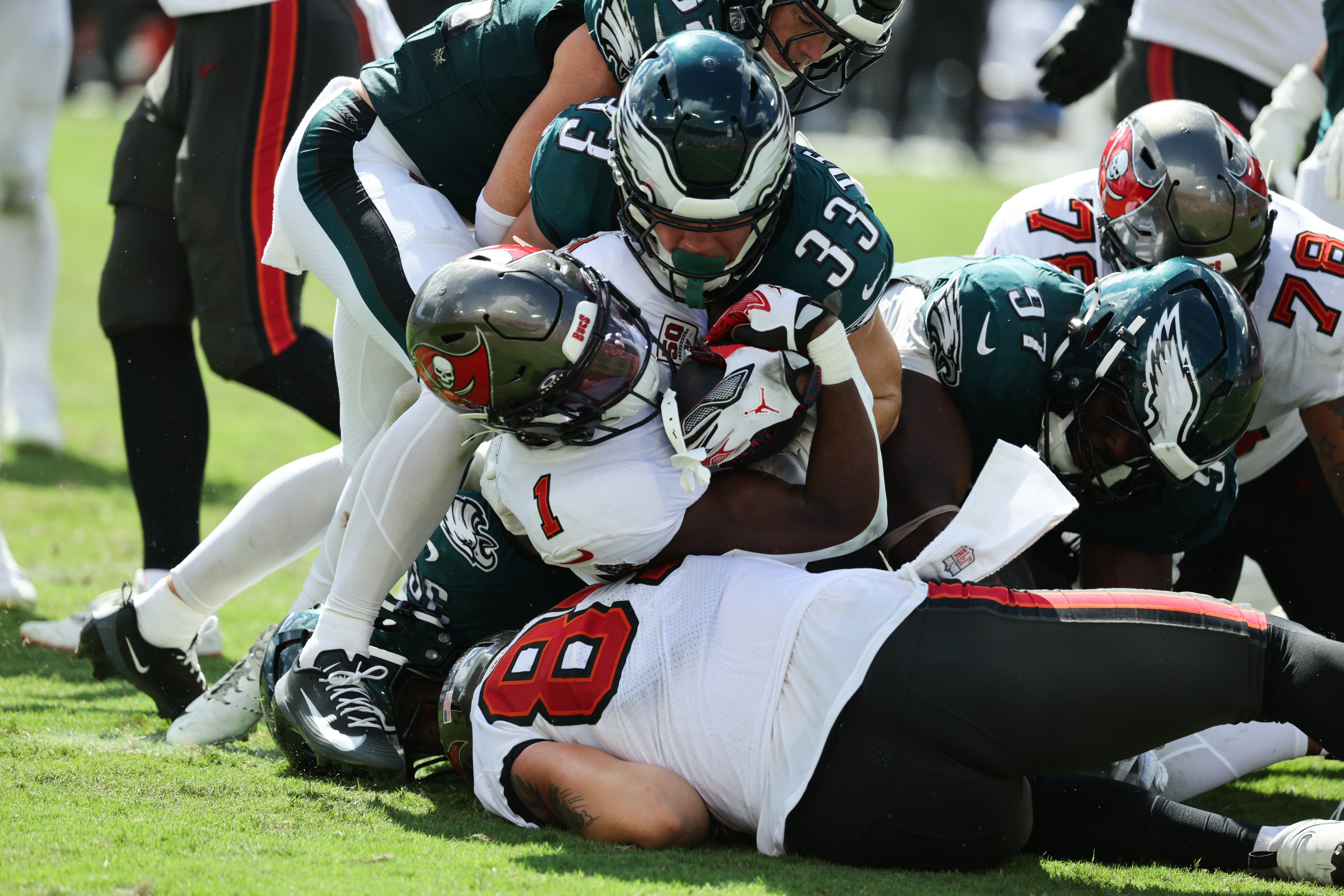 Tampa Bay Buccaneers running back Rachaad White (1) is tackled by Philadelphia Eagles cornerback Cooper Dejean (33) in the second half at Raymond James Stadium.