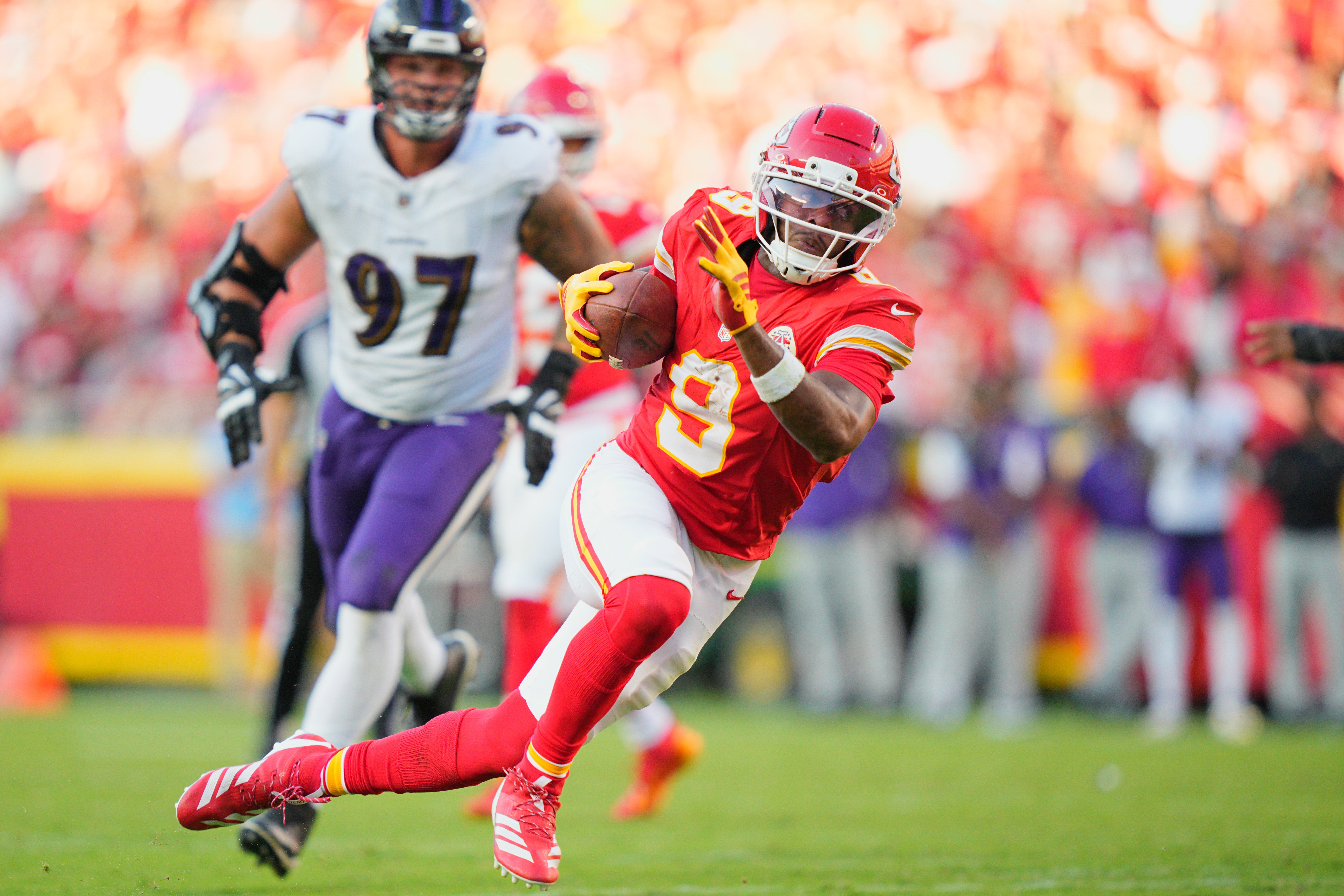 Kansas City Chiefs wide receiver JuJu Smith-Schuster (9) runs with the ball as Baltimore Ravens defensive end Brent Urban (97) defends