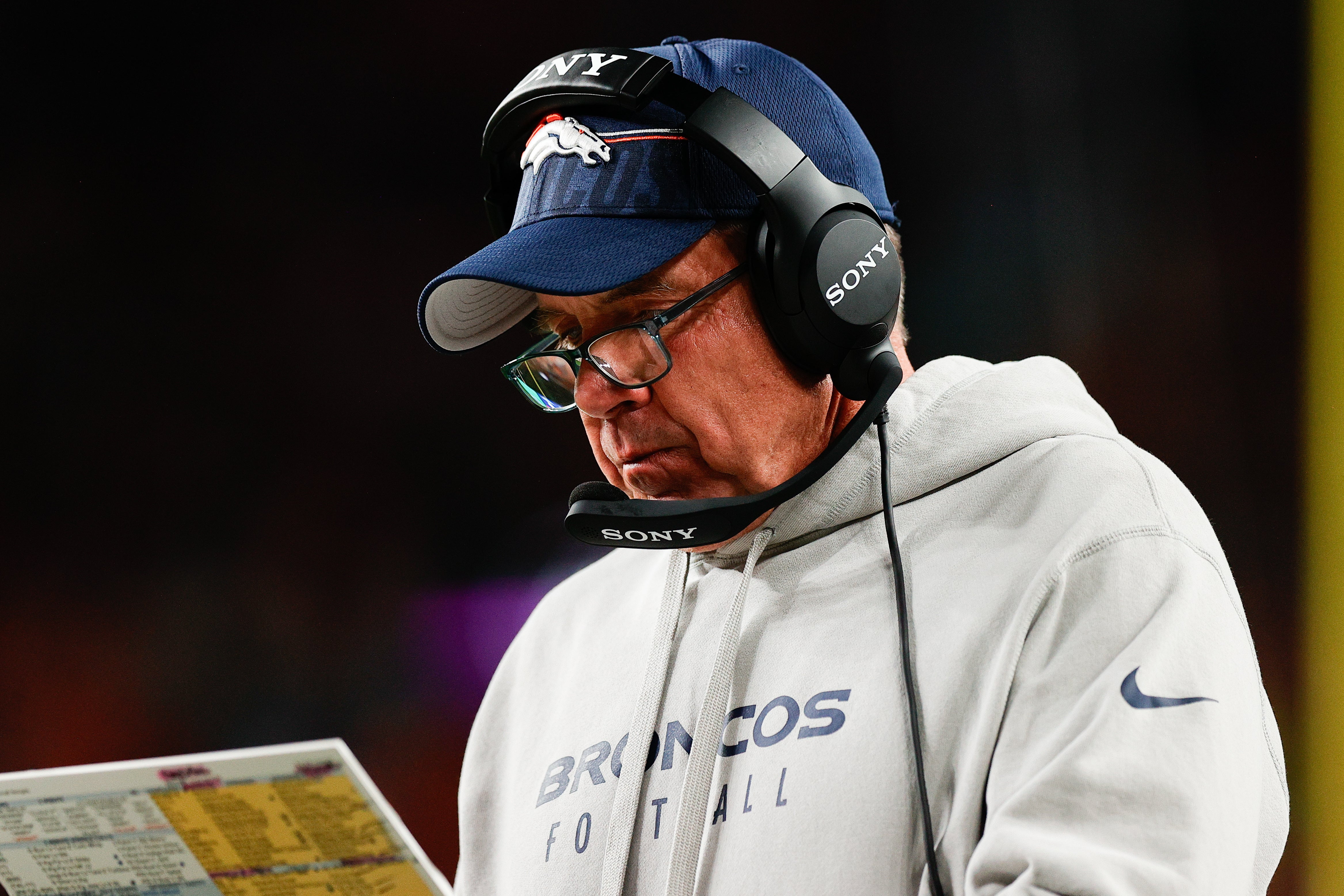 Sep 29, 2025; Denver, Colorado, USA; Denver Broncos head coach Sean Payton looks at his notes during the third quarter against the Cincinnati Bengals at Empower Field at Mile High.