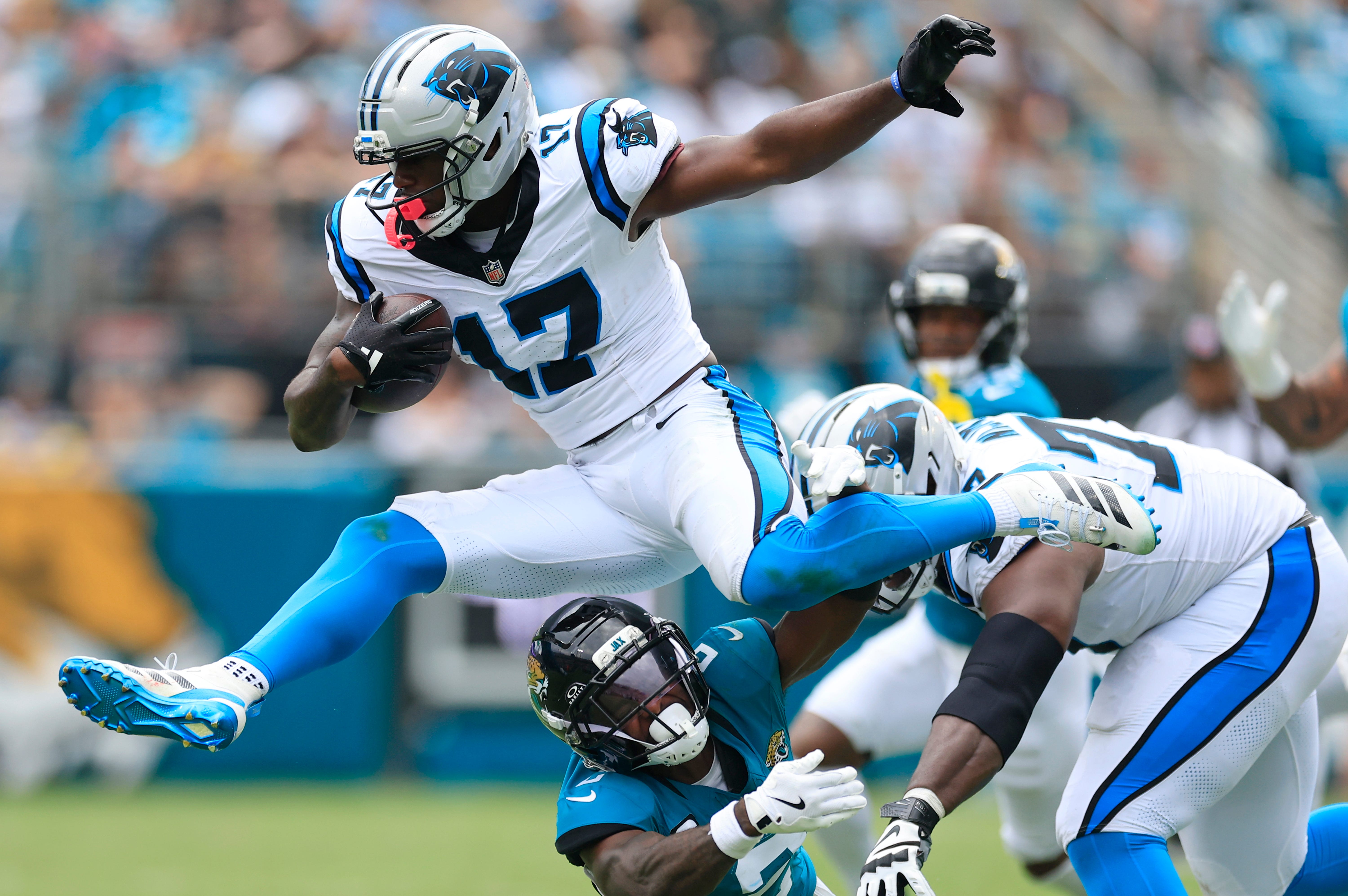 Carolina Panthers wide receiver Xavier Legette (17) leaps over Jacksonville Jaguars cornerback Jourdan Lewis (2) during the second quarter of an NFL football matchup at EverBank Stadium, Sunday, Sept. 7, 2025 in Jacksonville, Fla.