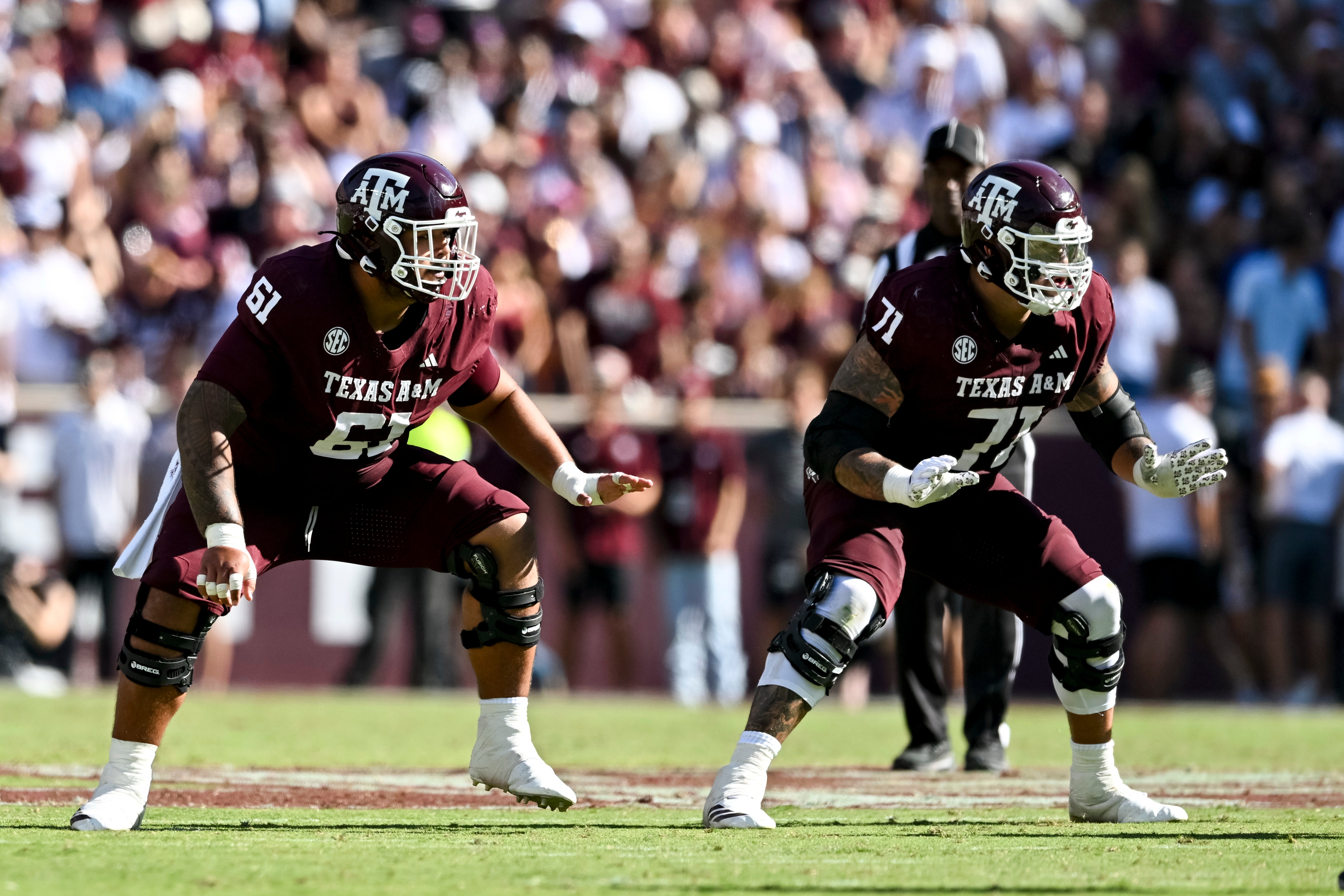 Sep 27, 2025; College Station, Texas, USA; Texas A&M Aggies offensive lineman Koli Faaiu (61) and offensive lineman Chase Bisontis (71) block against the Auburn Tigers during the second quarter at Kyle Field.