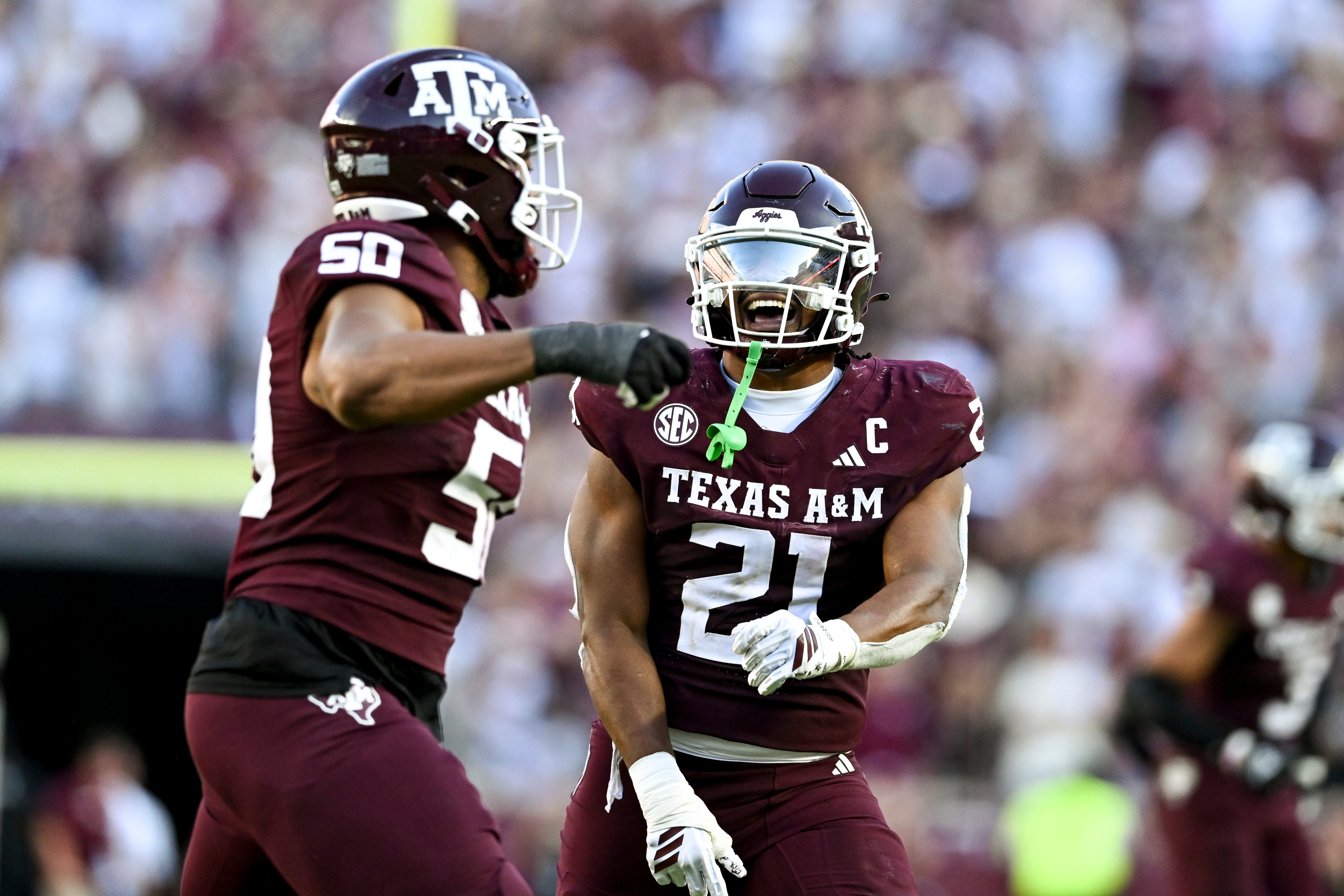 Sep 27, 2025; College Station, Texas, USA; Texas A&M Aggies linebacker Taurean York (21) celebrates with defensive end Dayon Hayes (50) against the Auburn Tigers during the fourth quarter at Kyle Field.