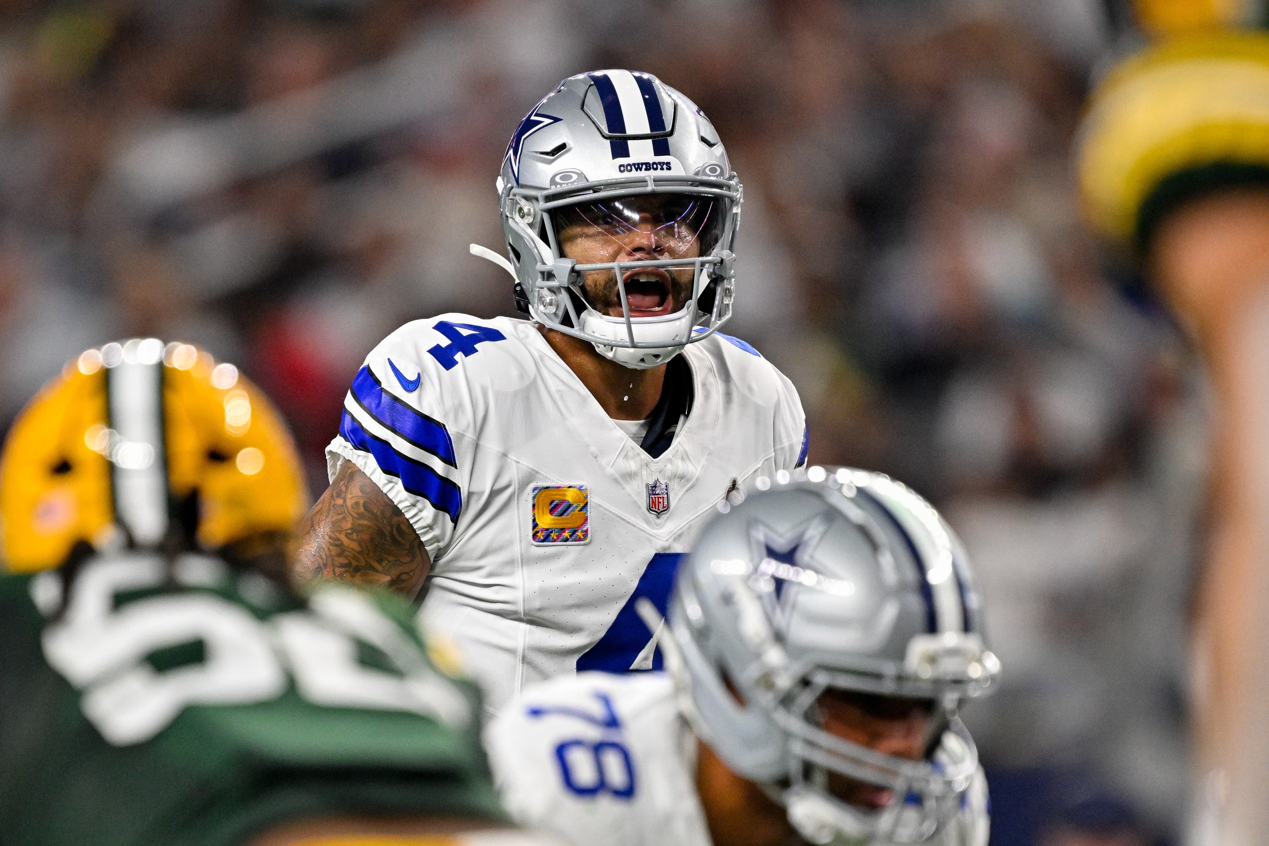 Sep 28, 2025; Arlington, Texas, USA; Dallas Cowboys quarterback Dak Prescott (4) looks to set the play during the game between the Dallas Cowboys and the Green Bay Packers at AT&T Stadium.