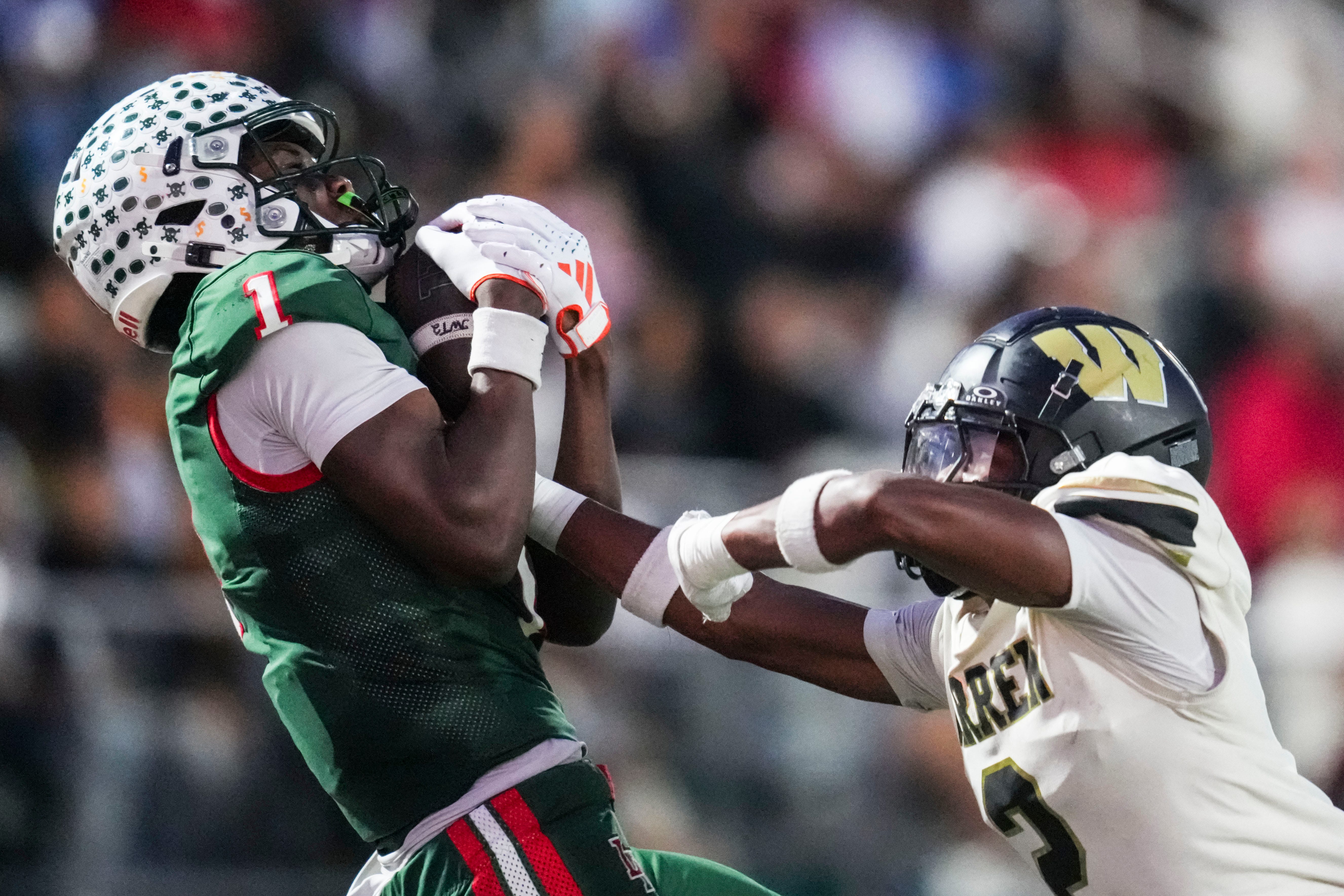 Lawrence North Wildcats Monshun Sales (1) catches a pass against Warren Central Terrell Harris (2) on Friday, Oct. 3, 2025, during a game between the Lawrence North Wildcats and Warren Central at Lawrence North High School in Indianapolis.