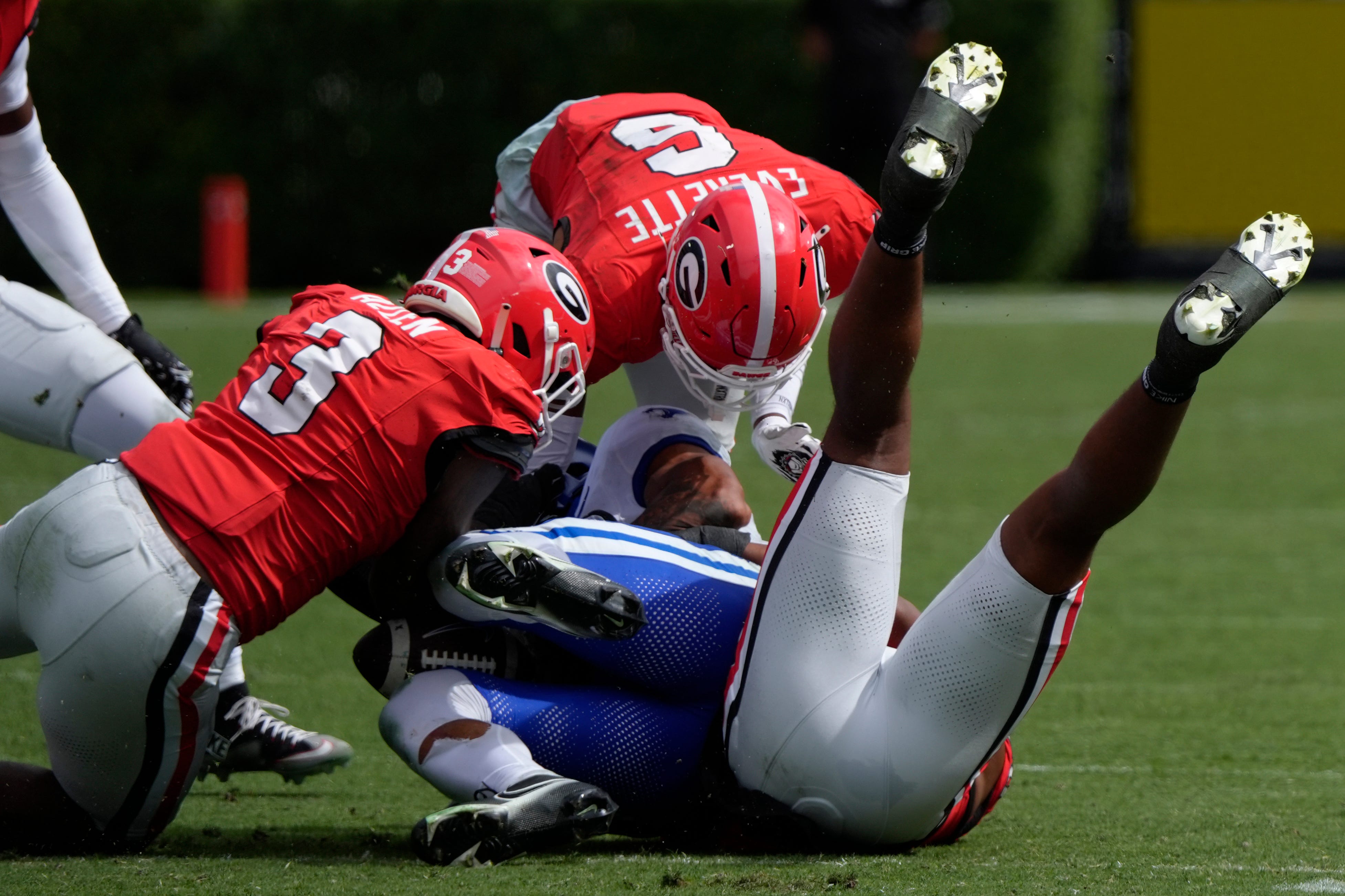 Georgia linebacker CJ Allen (3) rips the ball out of the hands of Kentucky running back Seth McGowan (3) for a turn over during the second half of a NCAA college football game against Kentucky in Athens