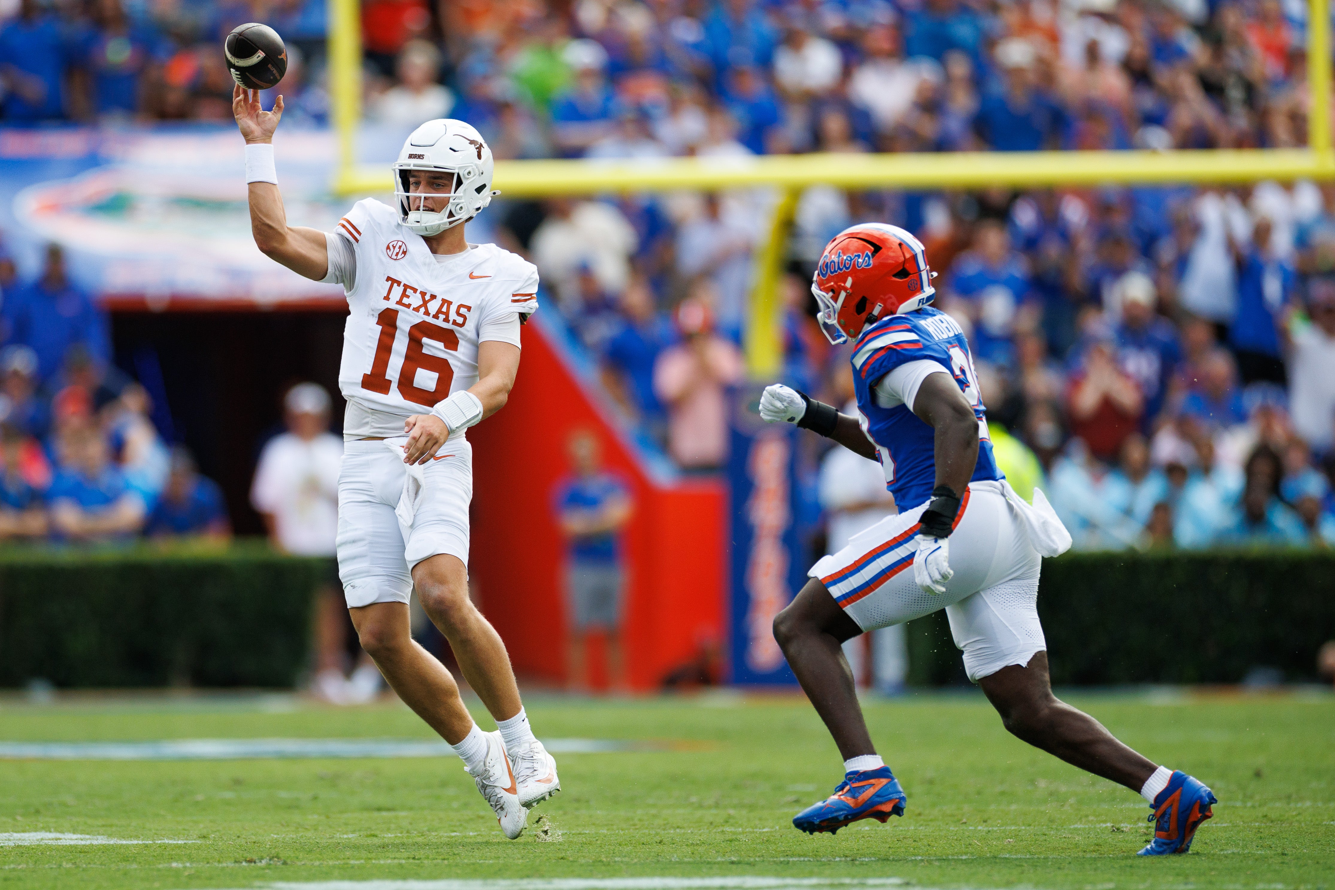 Oct 4, 2025; Gainesville, Florida, USA; Texas Longhorns quarterback Arch Manning (16) throws under pressure from Florida Gators linebacker Jaden Robinson (29) during the first half at Ben Hill Griffin Stadium.