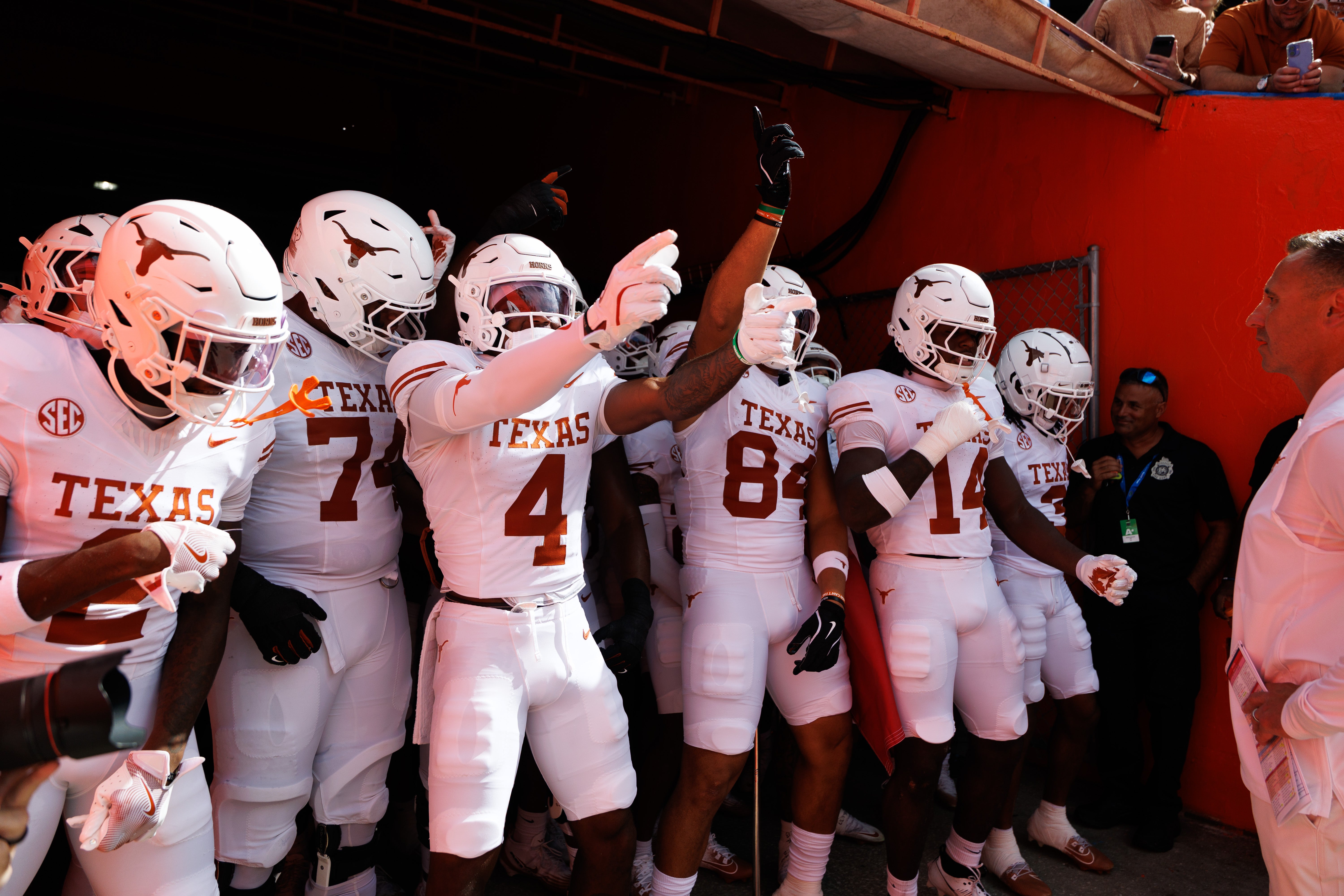 Oct 4, 2025; Gainesville, Florida, USA; Texas Longhorns running back CJ Baxter (4) and Texas Longhorns tight end Jordan Washington (84) gesture with teammates before a game against the Florida Gators at Ben Hill Griffin Stadium. Mandatory Credit: Matt Pendleton-Imagn Images