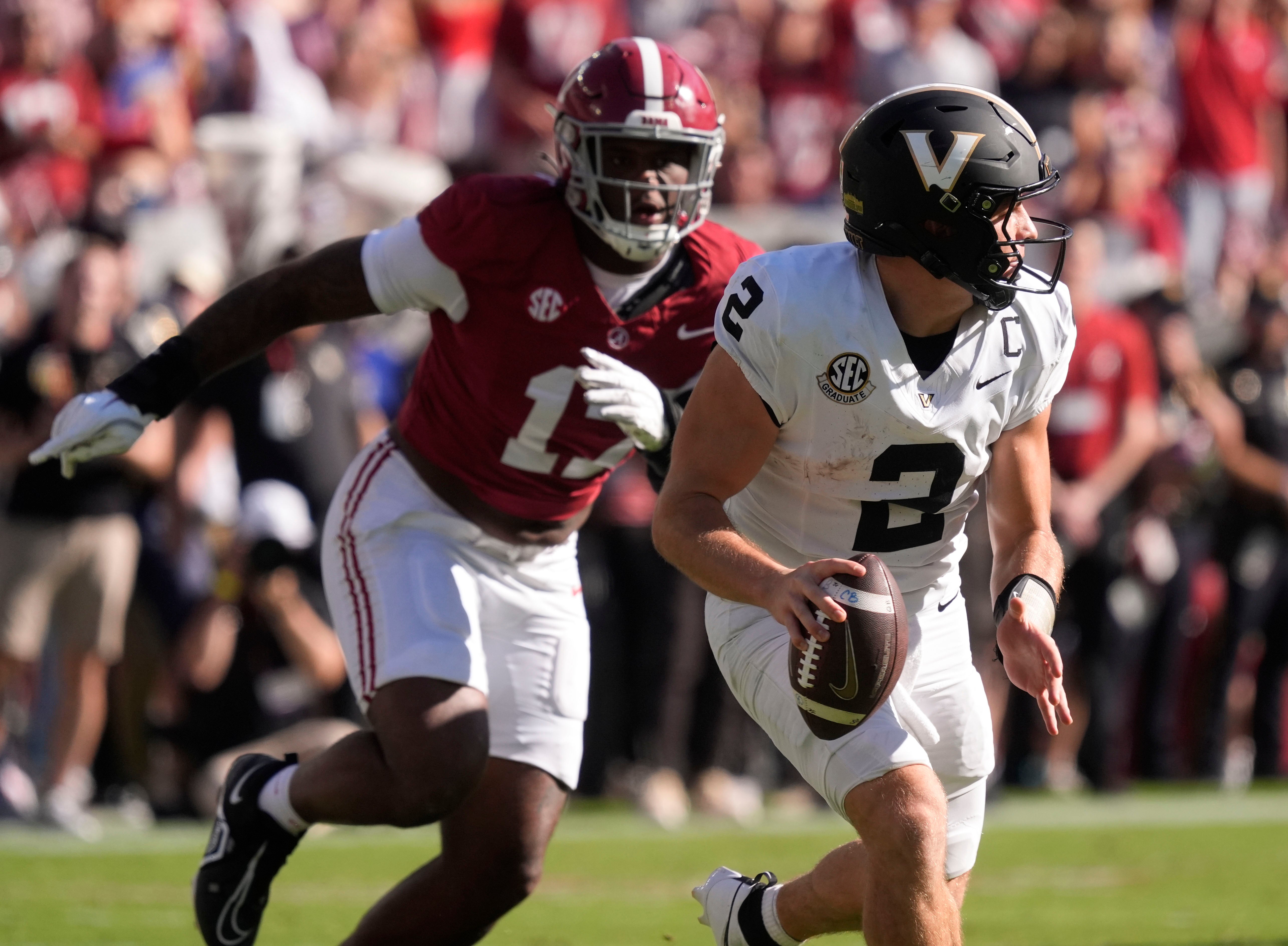 Oct 4, 2025; Tuscaloosa, Alabama, USA; Vanderbilt quarterback Diego Pavia (2) rolls away from pressure by Alabama linebacker Kelby Collins (17) at Saban Field at Bryant-Denny Stadium.