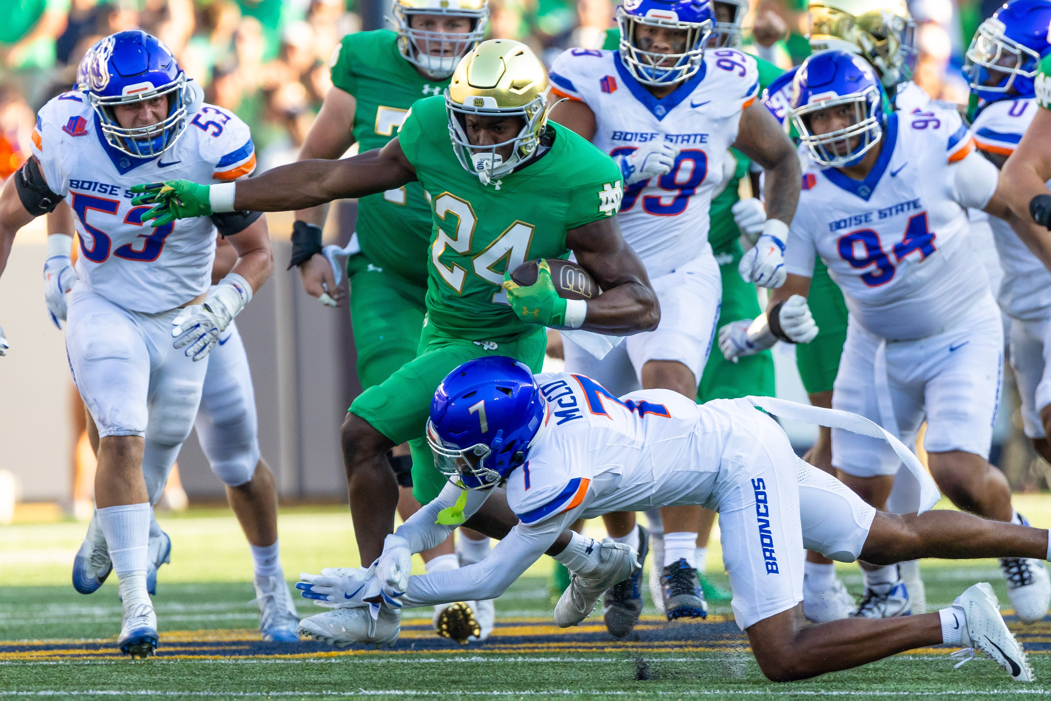 Oct 4, 2025; South Bend, Indiana, USA; Notre Dame Fighting Irish running back Jadarian Price (24) tries to get past Boise State Broncos defensive back A'Marion McCoy (7) during the second half at Notre Dame Stadium. Mandatory Credit: Michael Caterina-Imagn Images