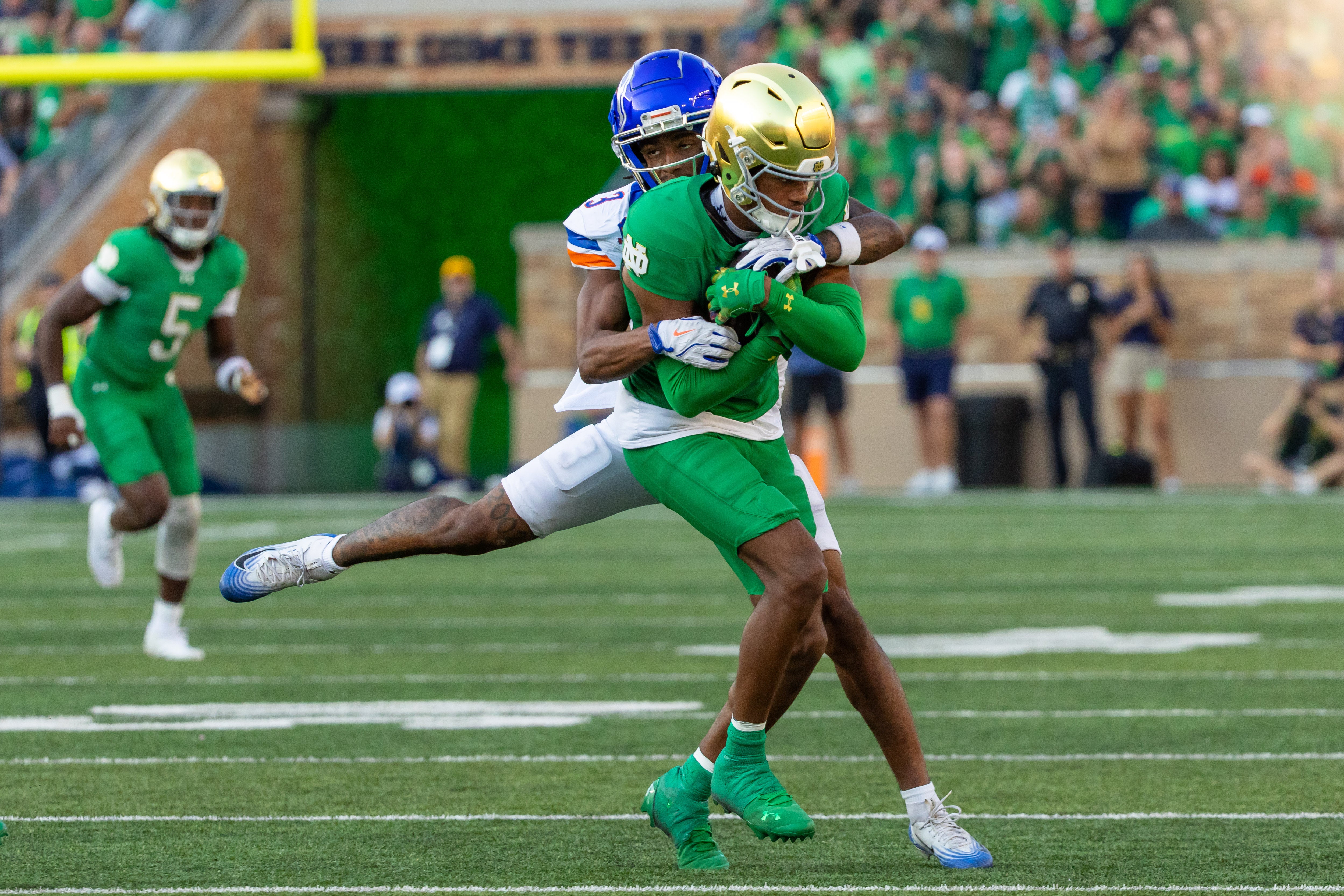 Oct 4, 2025; South Bend, Indiana, USA; Boise State Broncos wide receiver Latrell Caples (3) tackles Notre Dame Fighting Irish cornerback Leonard Moore (15) after he made an interception during the second half at Notre Dame Stadium. Mandatory Credit: Michael Caterina-Imagn Images