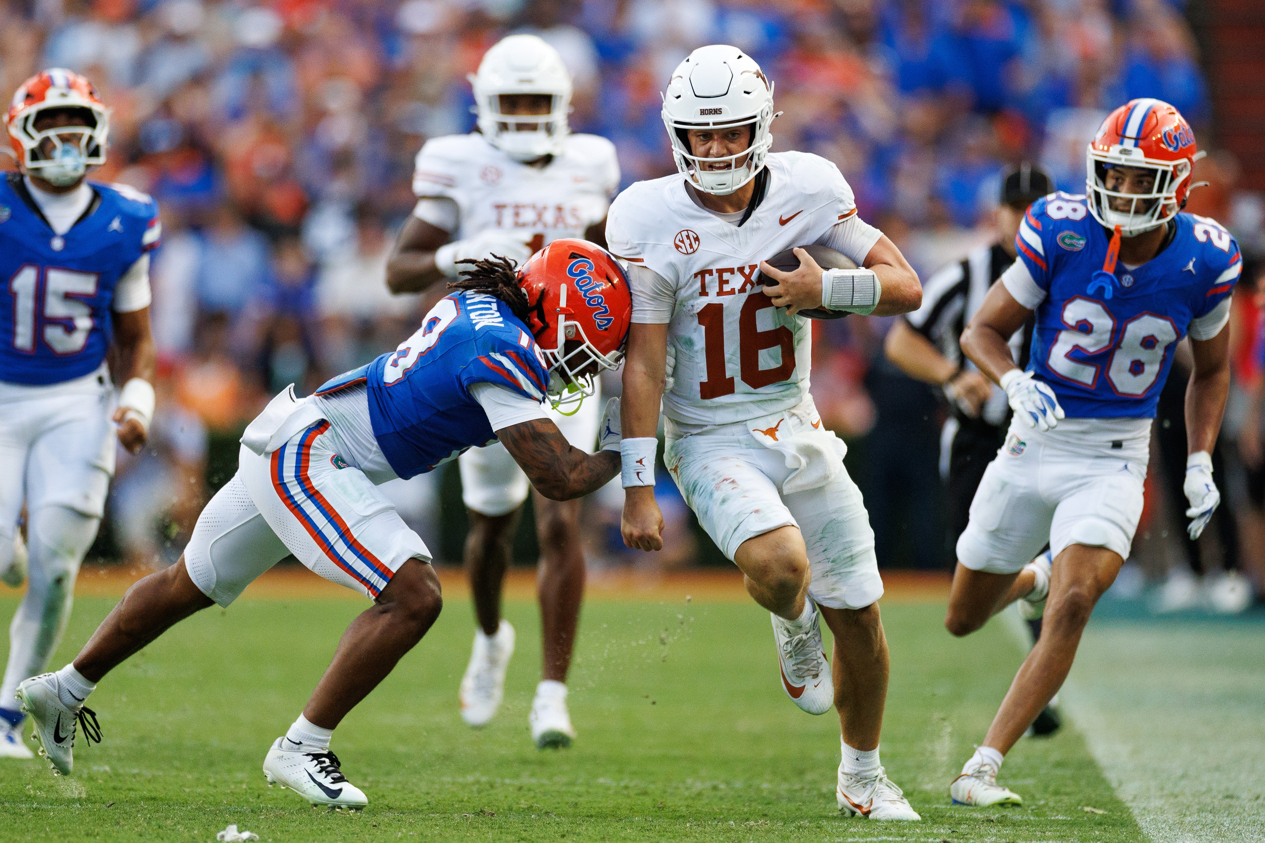 Oct 4, 2025; Gainesville, Florida, USA; Florida Gators linebacker Aaron Chiles (8) pushes Texas Longhorns quarterback Arch Manning (16) out of bounds during the second half at Ben Hill Griffin Stadium.