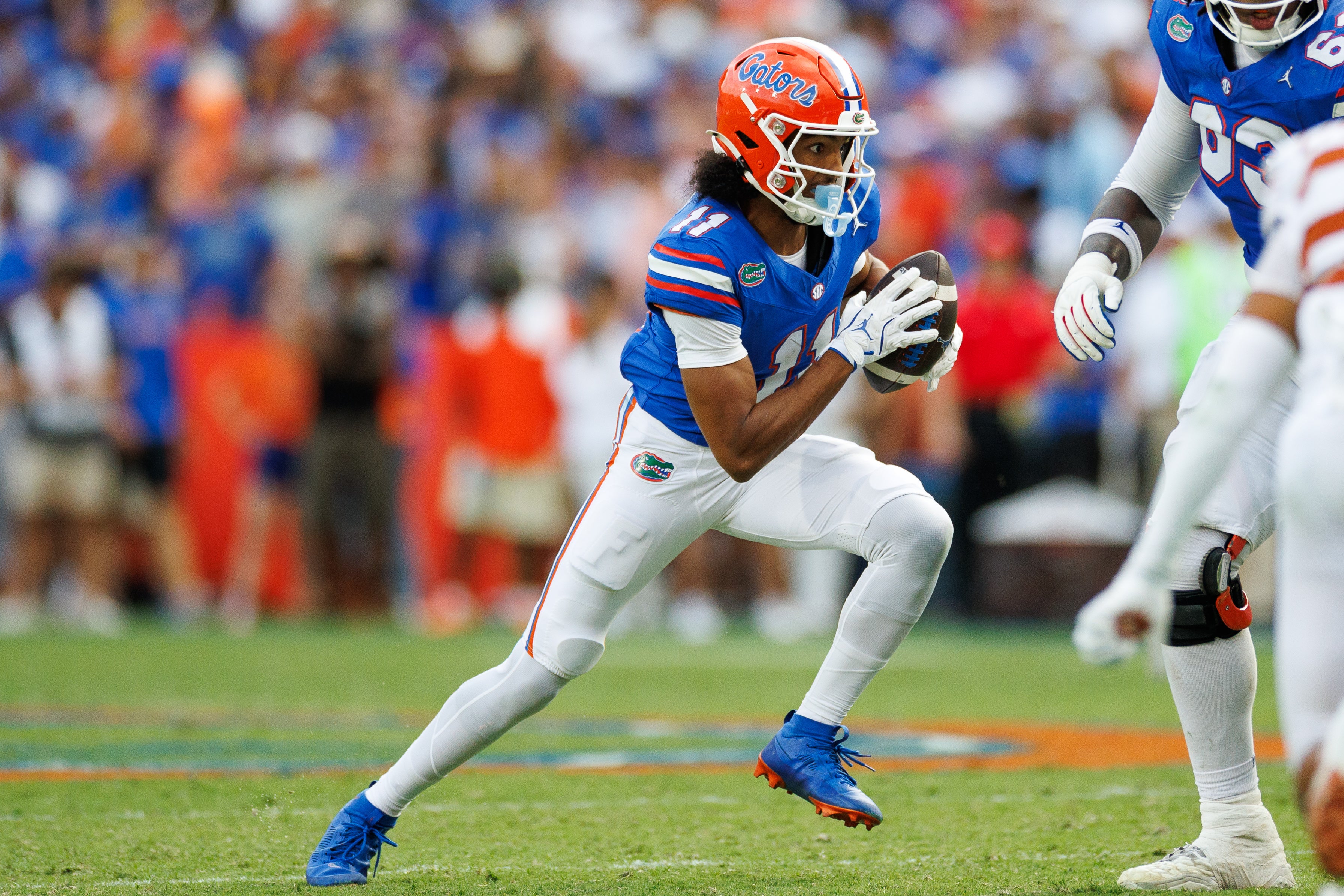 Oct 4, 2025; Gainesville, Florida, USA; Florida Gators wide receiver Aidan Mizell (11) runs with the ball against the Texas Longhorns during the second half at Ben Hill Griffin Stadium.