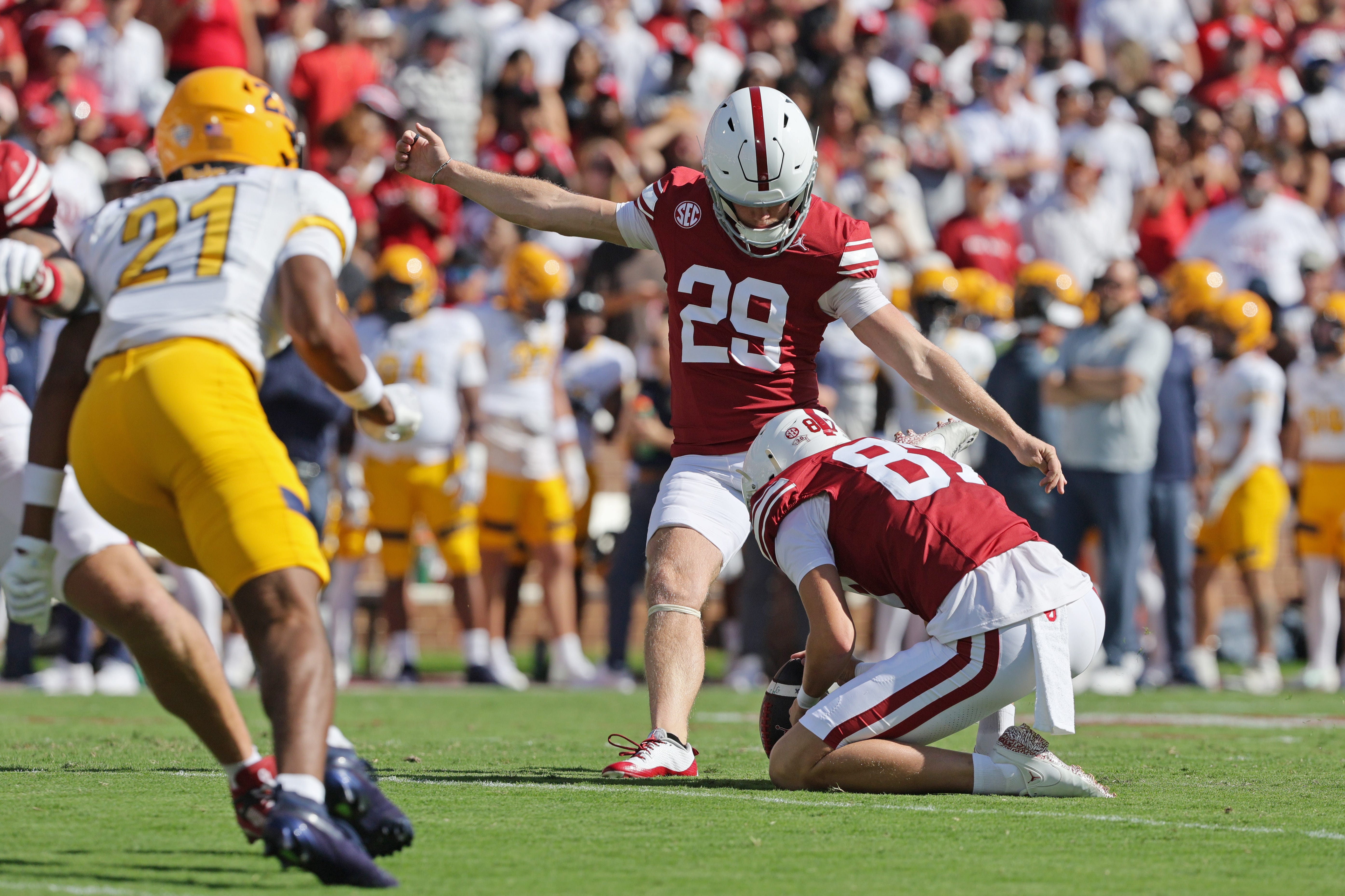 Oklahoma place kicker Tate Sandell (29) kicks an extra point as Jacob Ulrich (87) holds during the first half of an NCAA football game between the Oklahoma Sooners (OU) and Kent State Golden Flashes at Gaylord Family - Oklahoma Memorial Stadium in Norman, Okla., Saturday, Oct. 4, 2025.