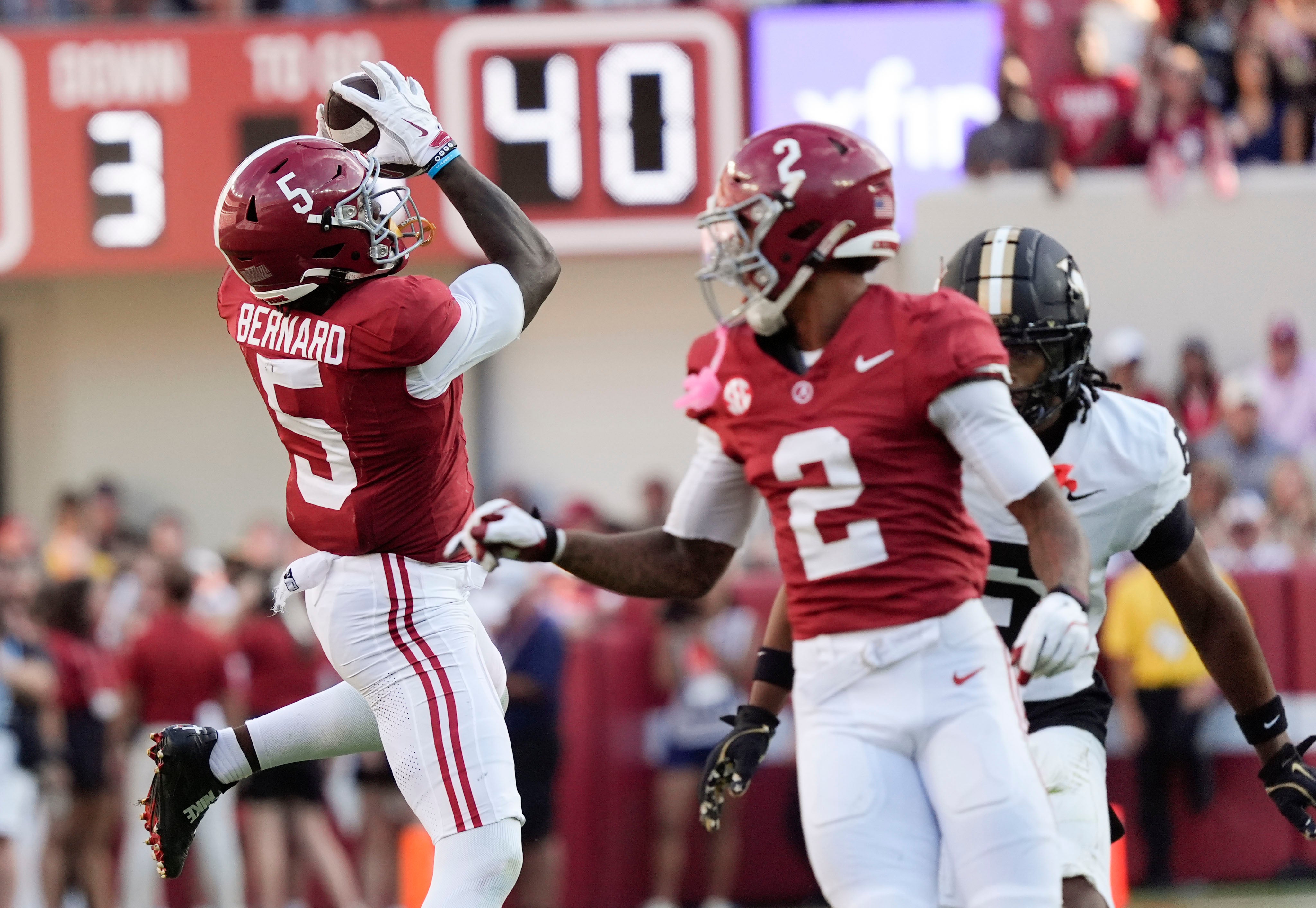 Oct 4, 2025; Tuscaloosa, Alabama, USA; Alabama wide receiver Germie Bernard (5) makes a catch with Alabama wide receiver Ryan Williams (2) and Vanderbilt defensive back Jordan Matthews (6) nearby at Saban Field at Bryant-Denny Stadium. Alabama downed Vanderbilt 30-14.