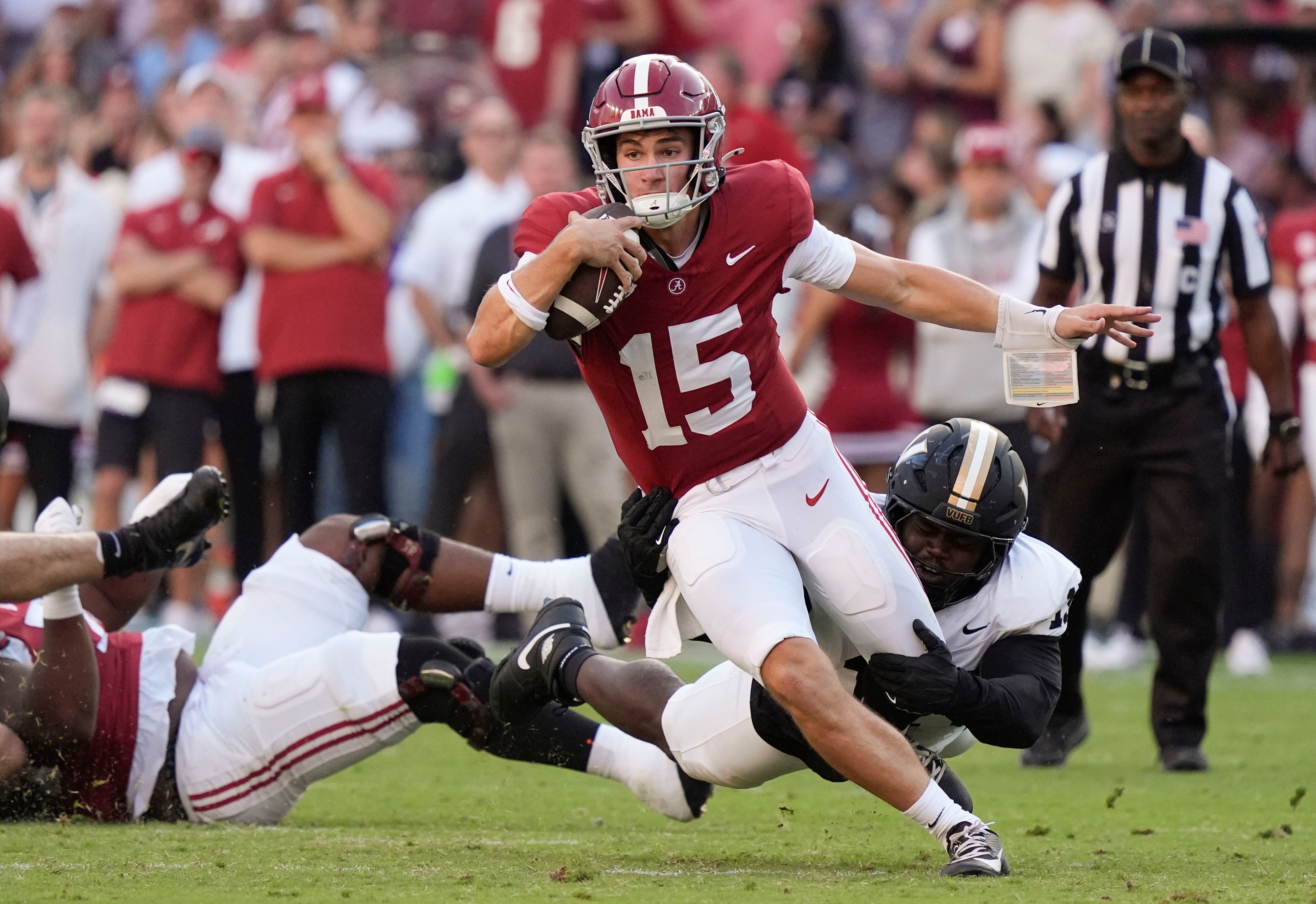 Oct 4, 2025; Tuscaloosa, Alabama, USA; Alabama quarterback Ty Simpson (15) is tripped up by Vanderbilt defensive lineman Zaylin Wood (15) at Saban Field at Bryant-Denny Stadium. Alabama downed Vanderbilt 30-14.