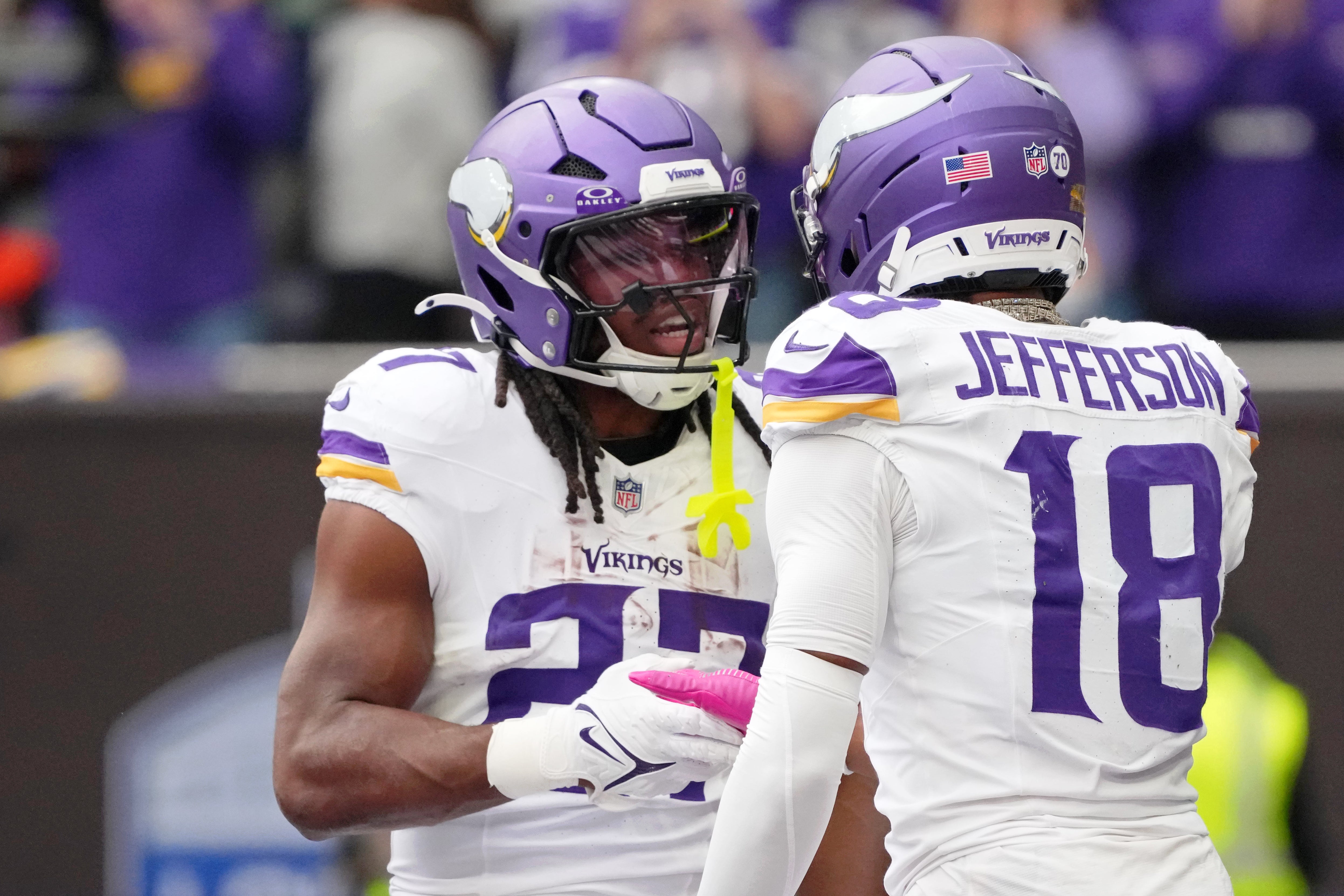 Oct 5, 2025; Tottenham, United Kingdom; Minnesota Vikings running back Jordan Mason (27) celebrates with wide receiver Justin Jefferson (18) after scoring a touchdown against the Cleveland Browns during the third quarter of an NFL International Series game at Tottenham Hotspur Stadium.