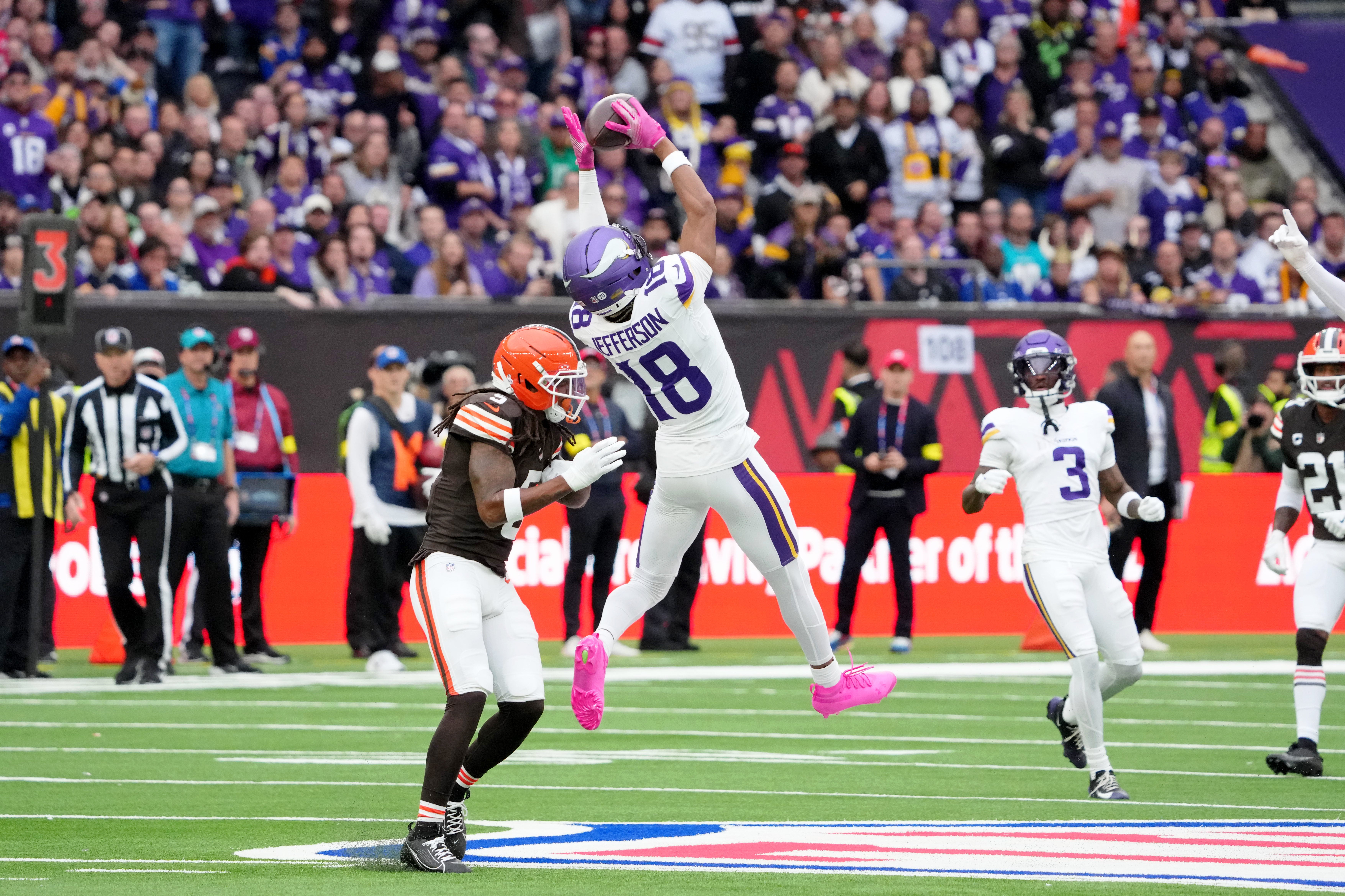 Oct 5, 2025; Tottenham, United Kingdom; Minnesota Vikings wide receiver Justin Jefferson (18) makes a catch against Cleveland Browns safety Rayshawn Jenkins (5) during the fourth quarter of an NFL International Series game at Tottenham Hotspur Stadium.