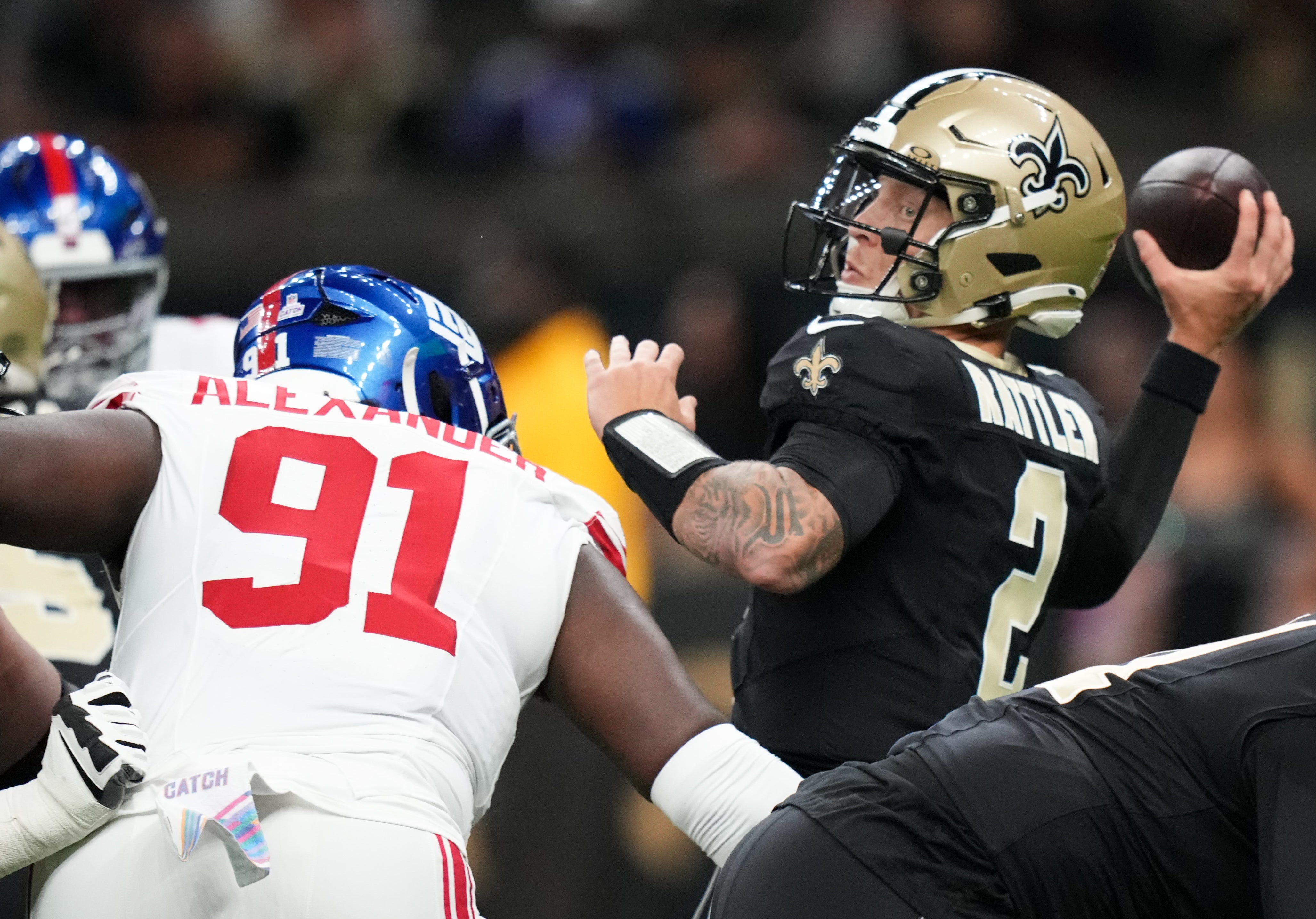 Oct 5, 2025; New Orleans, Louisiana, USA; New Orleans Saints quarterback Spencer Rattler (2) passes the ball as New York Giants defensive tackle Darius Alexander (91) applies pressure during the first quarter at Caesars Superdome.