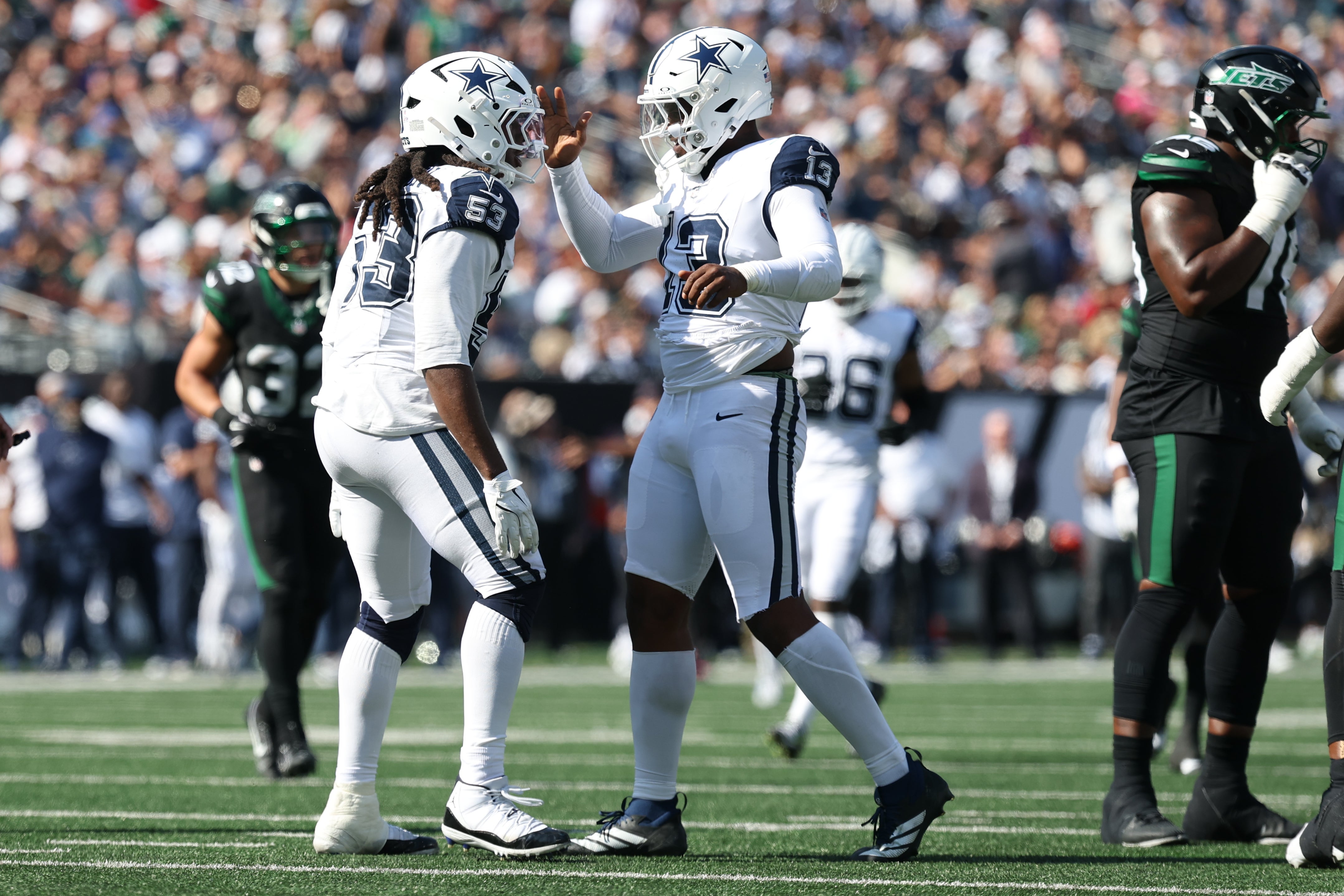 Oct 5, 2025; East Rutherford, New Jersey, USA; Dallas Cowboys defensive end James Houston (53) and defensive end Dante Fowler Jr. (13) reacts after a sack against the New York Jets during the first half at MetLife Stadium.