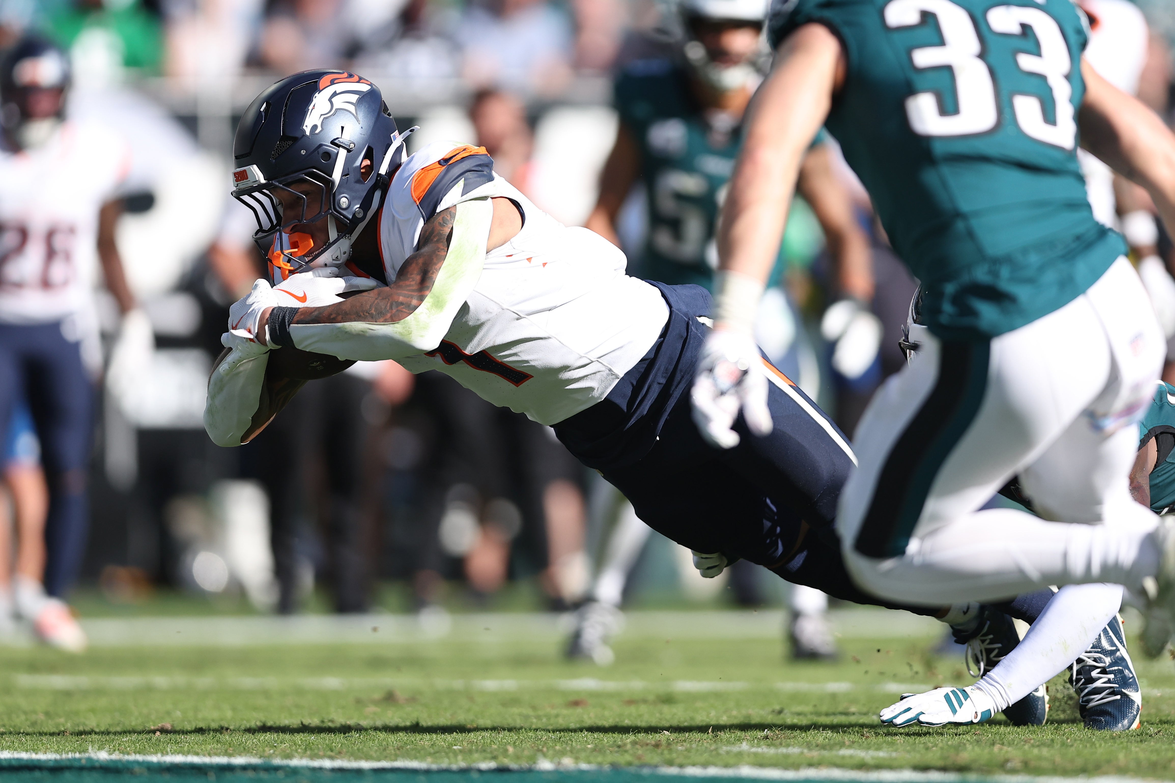 Oct 5, 2025; Philadelphia, Pennsylvania, USA; Denver Broncos tight end Evan Engram (1) dives to score a touchdown against the Philadelphia Eagles in the second half at Lincoln Financial Field.