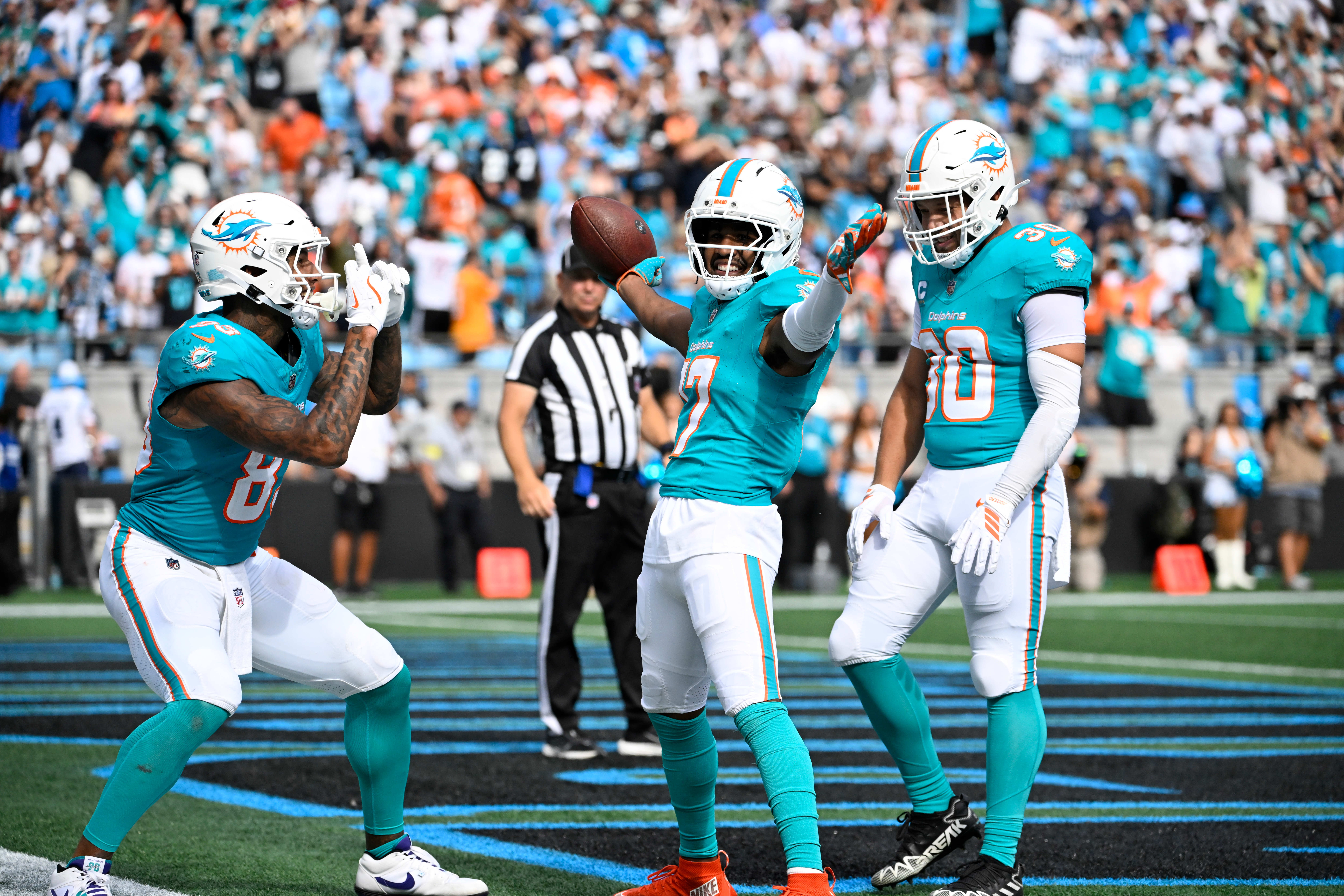 Oct 5, 2025; Charlotte, North Carolina, USA; Miami Dolphins wide receiver Jaylen Waddle (17) celebrates with tight end Darren Waller (83) and fullback Alec Ingold (30) after scoring a touchdown in the fourth quarter at Bank of America Stadium.