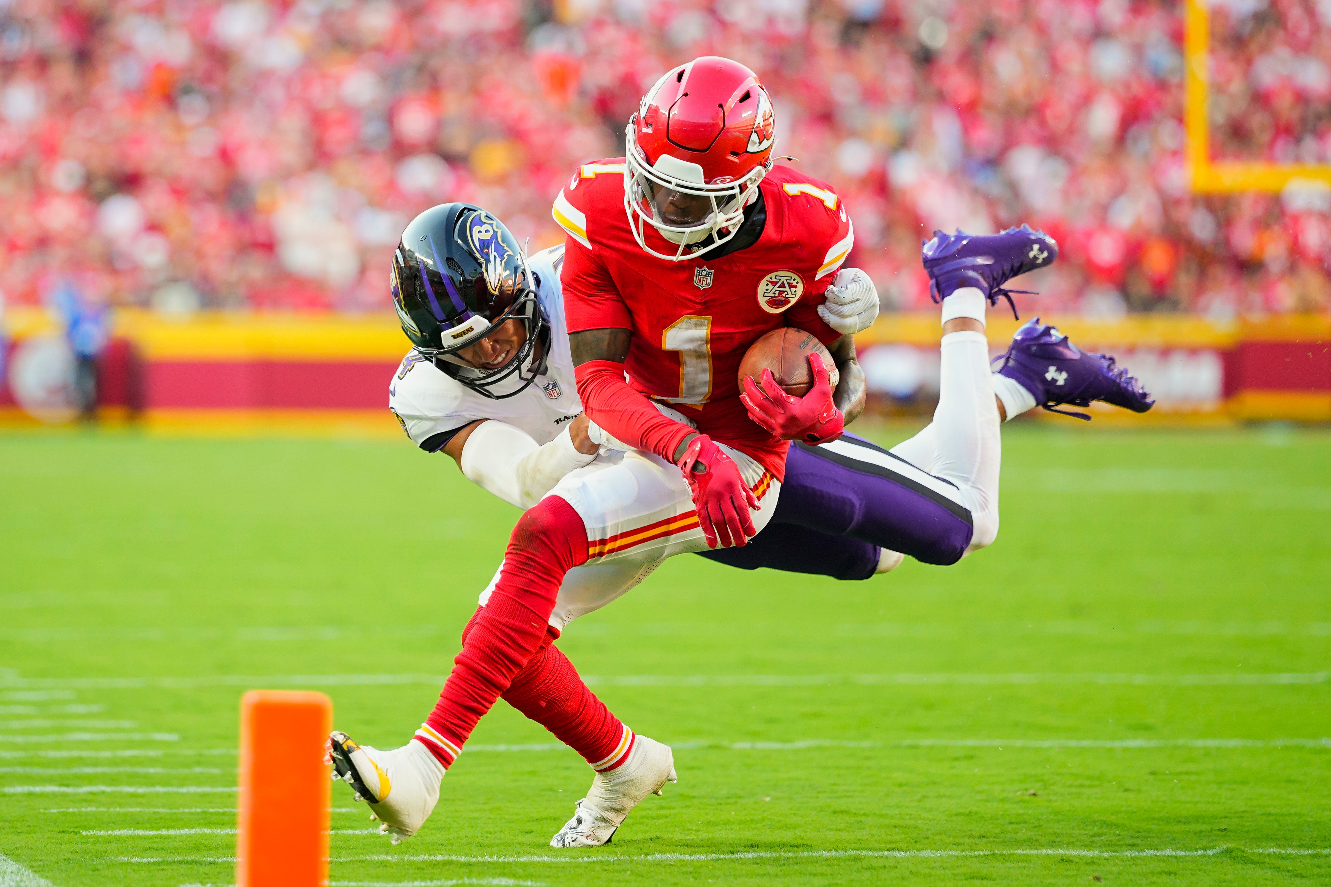 Kansas City Chiefs wide receiver Xavier Worthy (1) is tackled by Baltimore Ravens safety Kyle Hamilton (14)